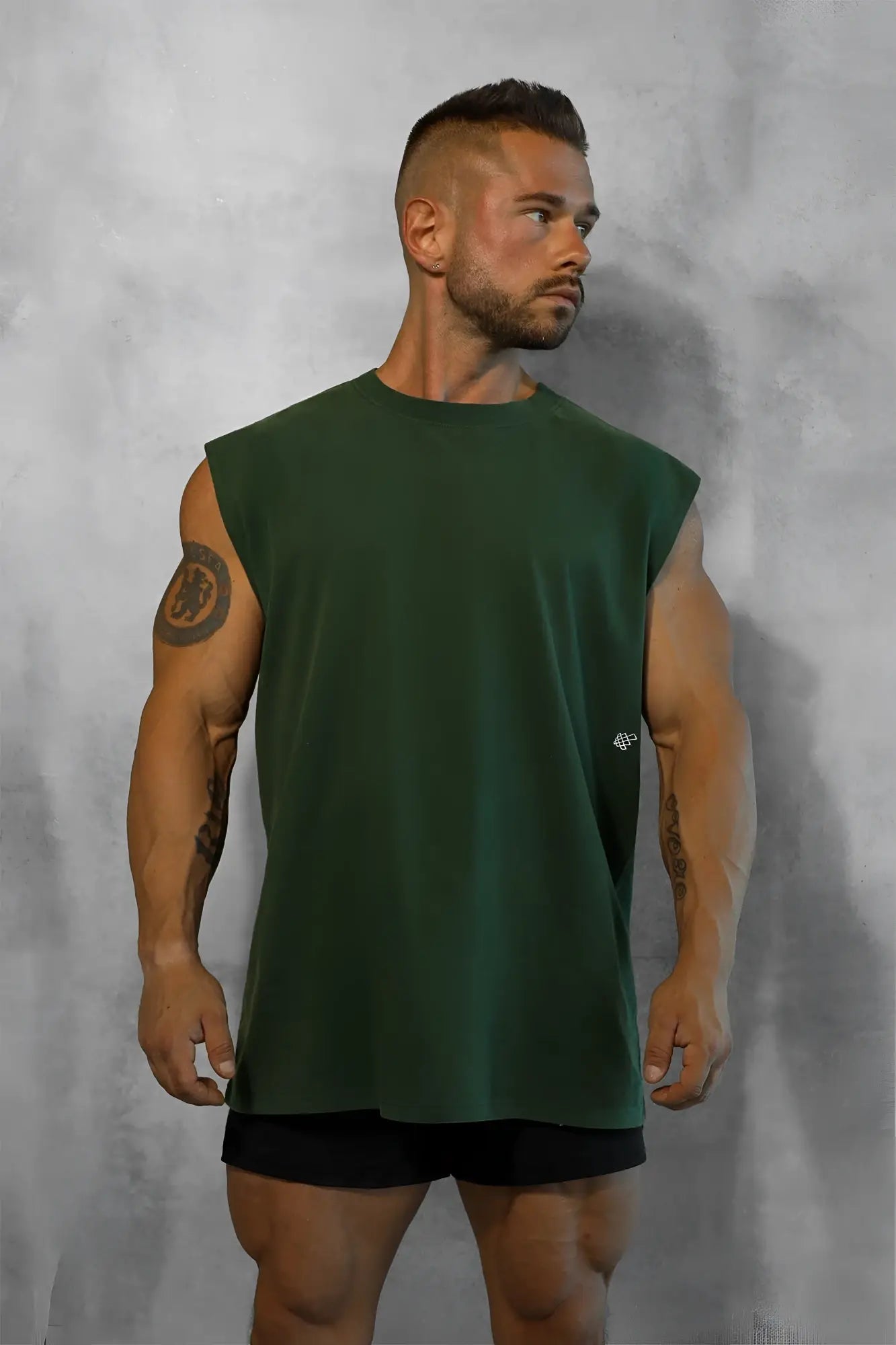 Dark green retro oversized sleeveless muscle tee with subtle logo on left chest for casual wear