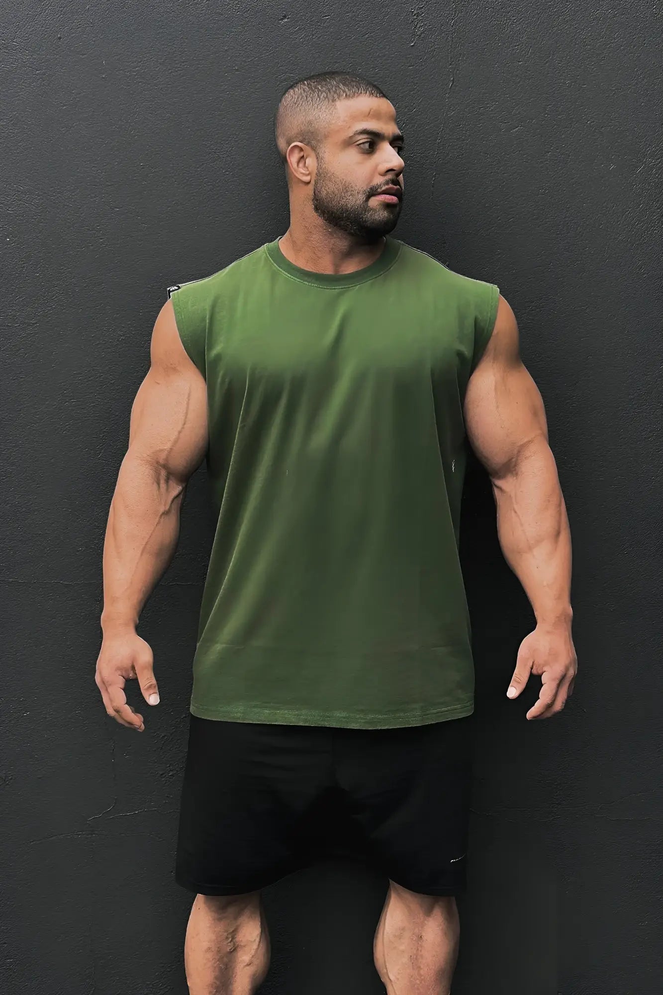 Olive green sleeveless cotton t-shirt with crew neck retro oversized muscle tee in forest green color
