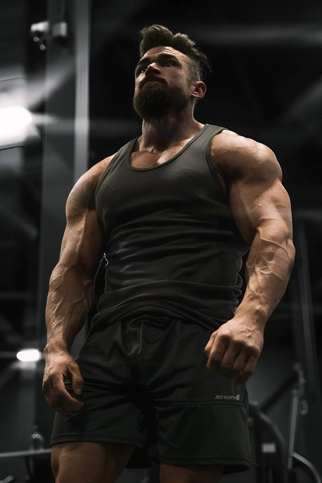 Dark olive green ribbed muscle tank top with a snug fit and sleeveless design for athletic wear