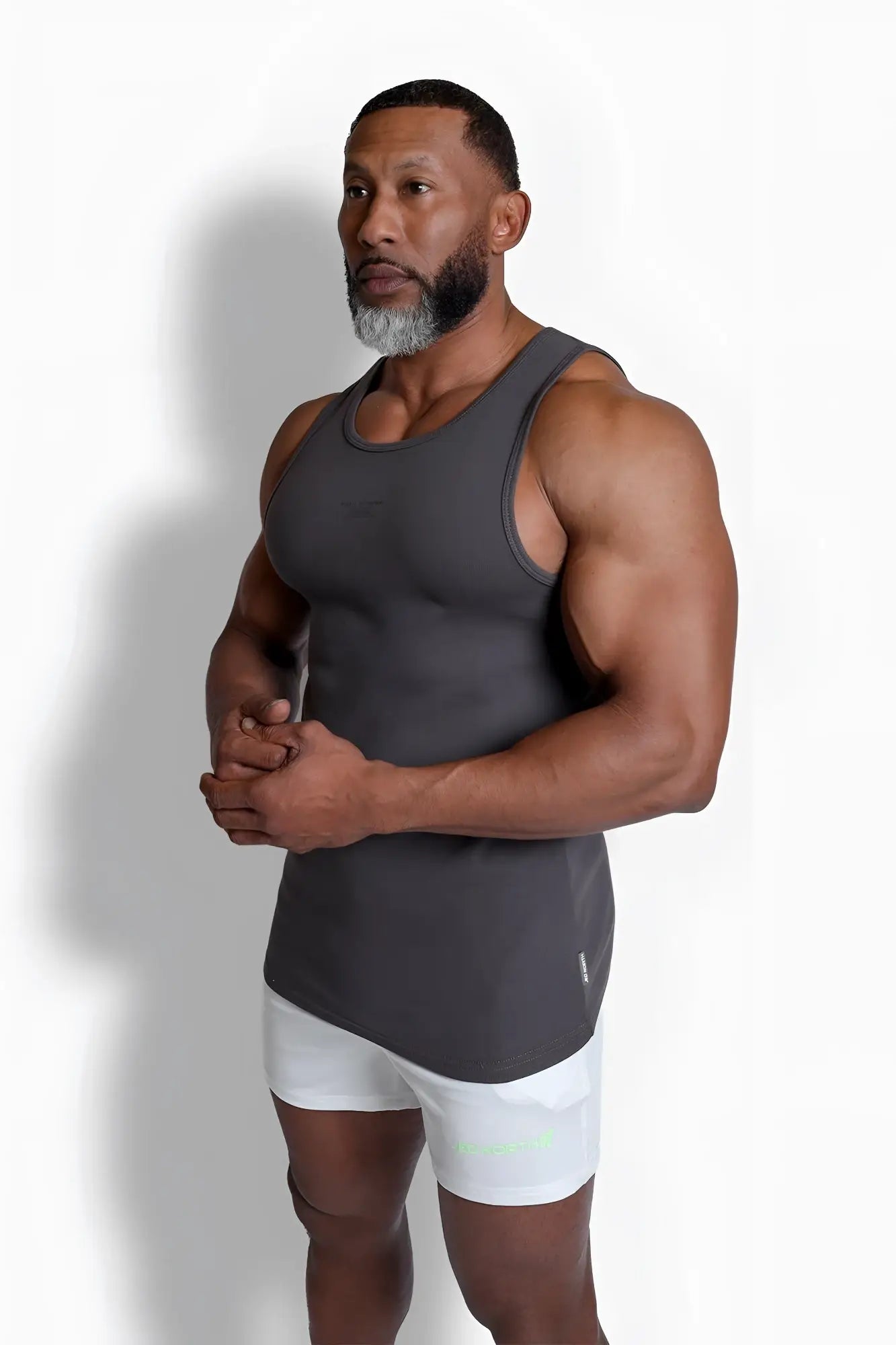 A sleek dark gray ribbed muscle tank top with fitted cut and subtle side seam detailing for athletic wear