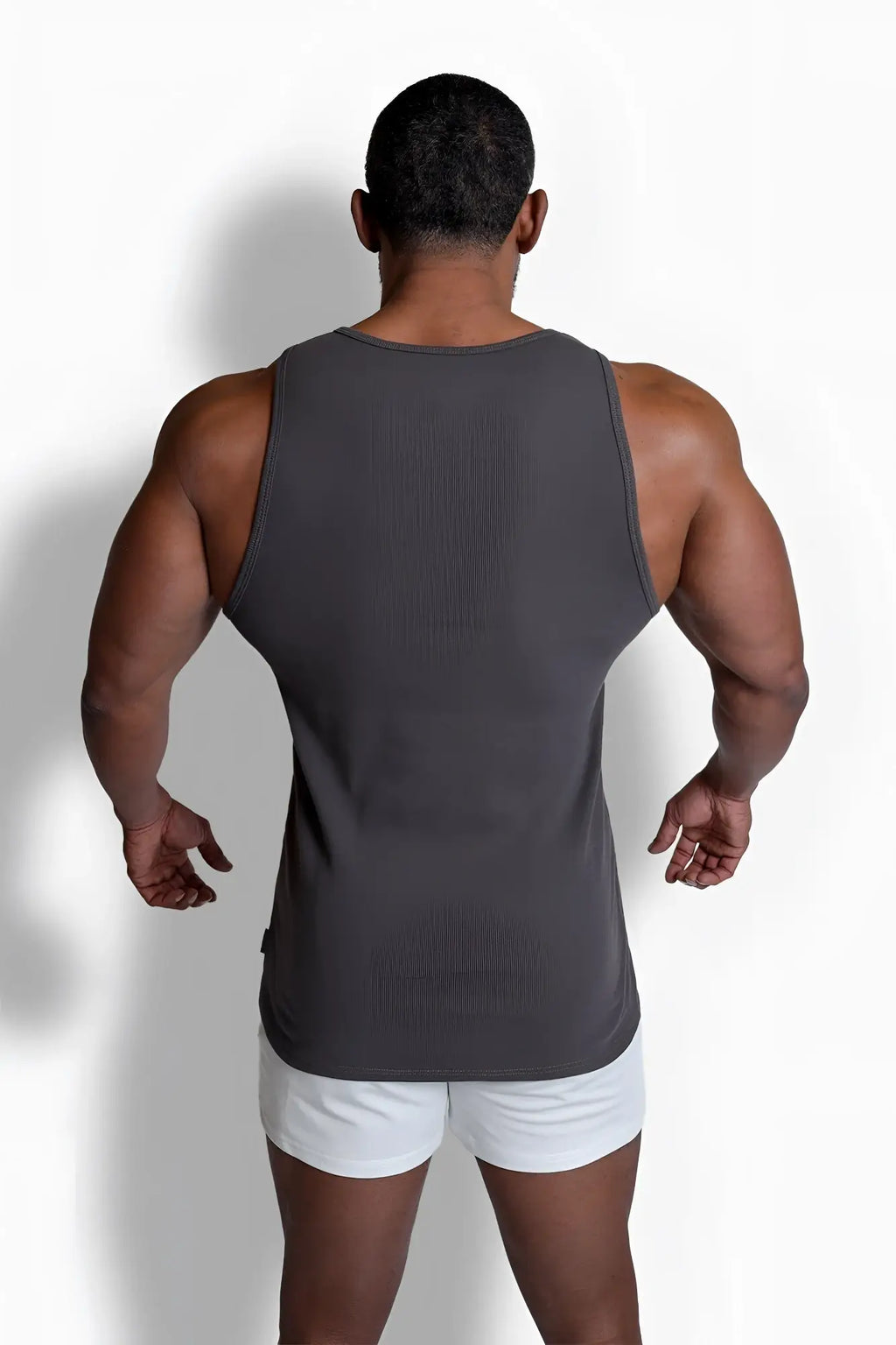 A sleek dark gray ribbed muscle tank top with sleeveless design and round neckline featuring clean seams