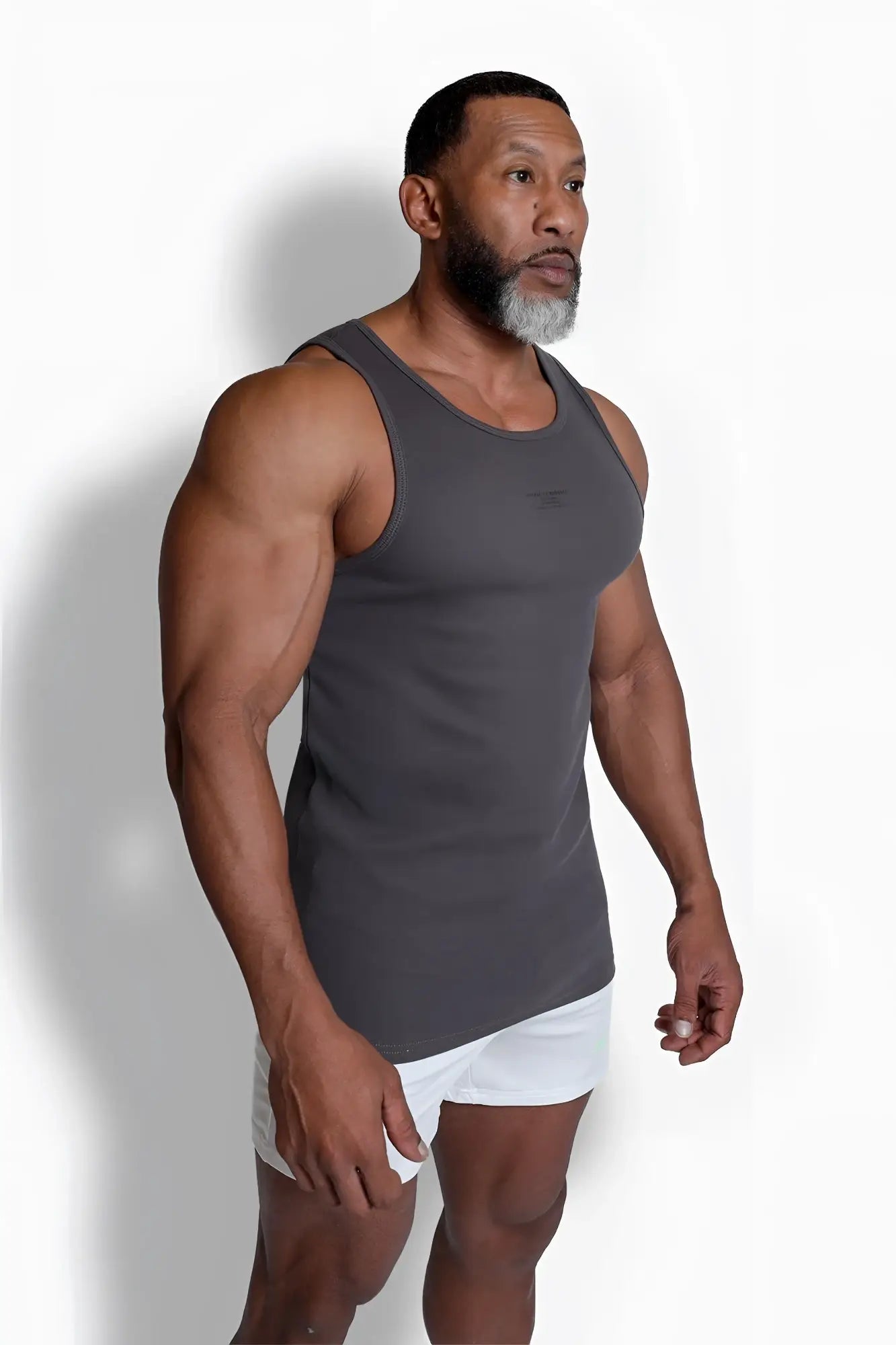 A dark gray ribbed muscle tank top with a sleeveless design and subtle brand logo on the chest