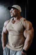 Beige ribbed muscle tank top in khaki with a small embroidered logo on the chest made from soft fabric