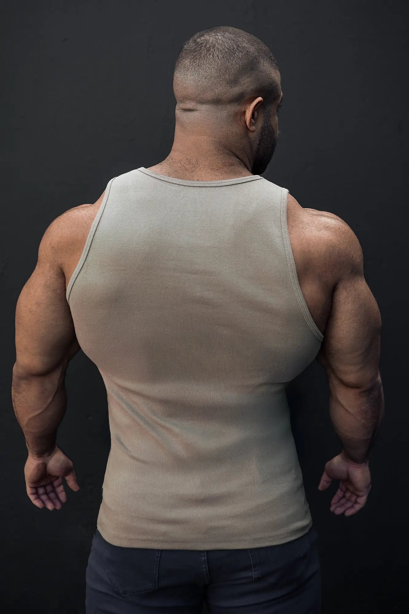 Beige ribbed muscle tank top with a simple round neckline sleeveless design in khaki color