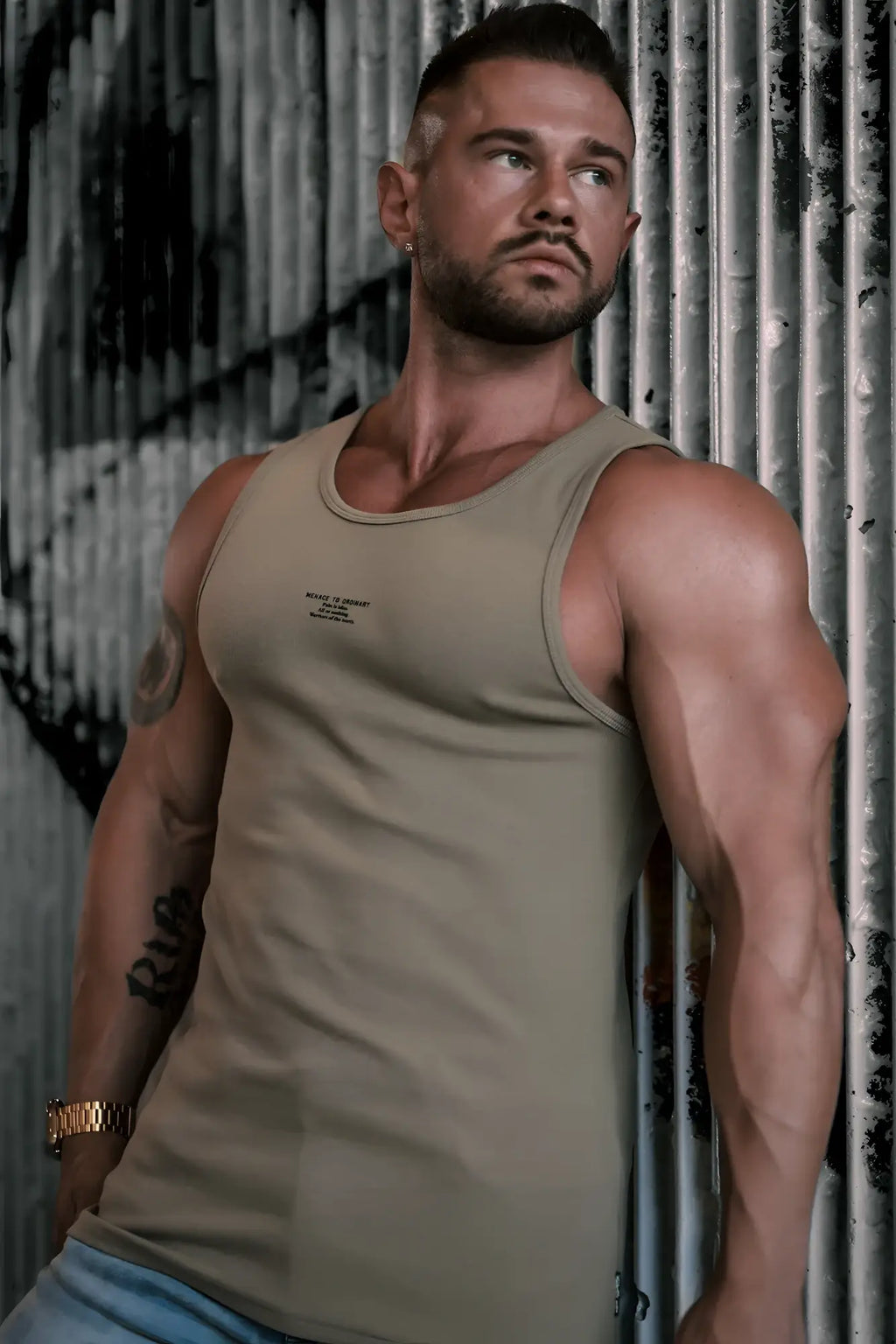A fitted ribbed muscle tank top in khaki olive green cotton with a subtle chest logo