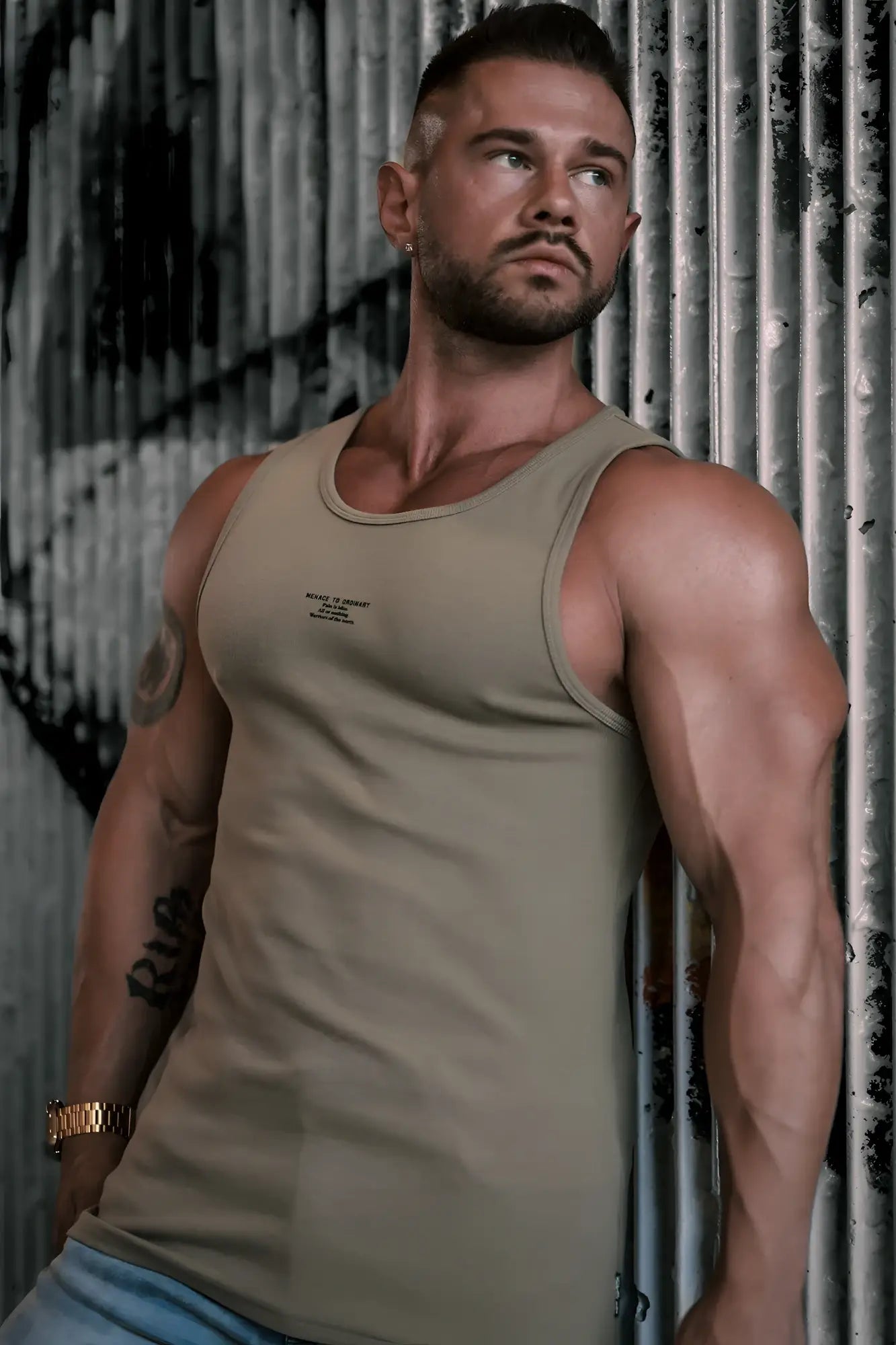 A fitted ribbed muscle tank top in khaki olive green cotton with a subtle chest logo
