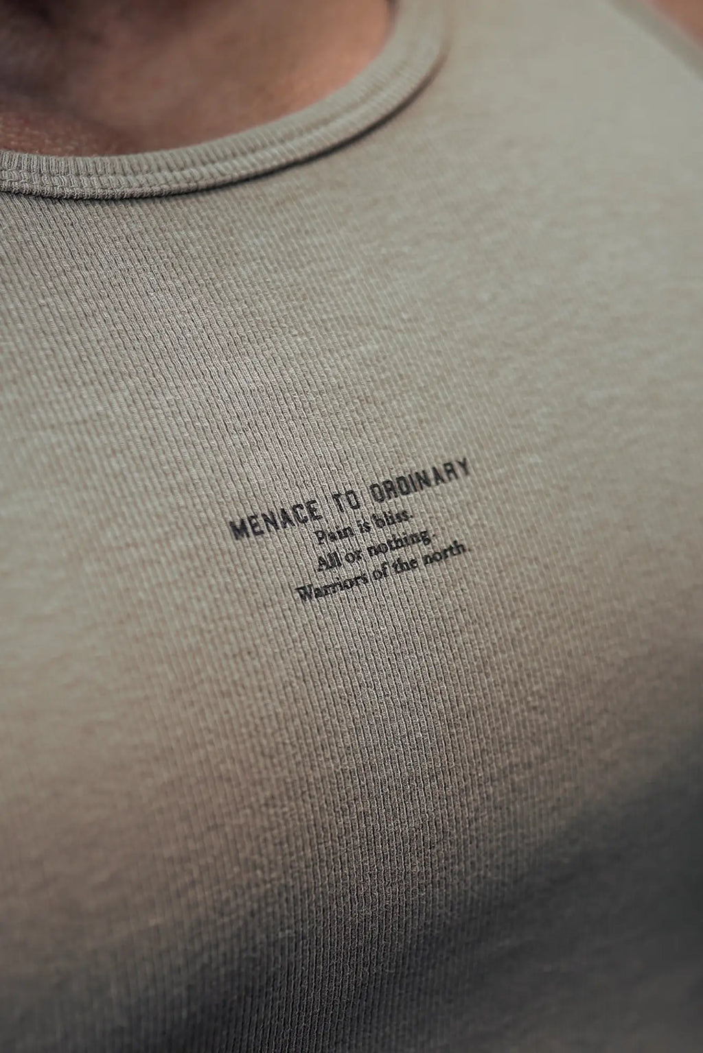 Ribbed muscle tank top in soft olive green with black minimalist text print menace to ordinary and ribbed texture