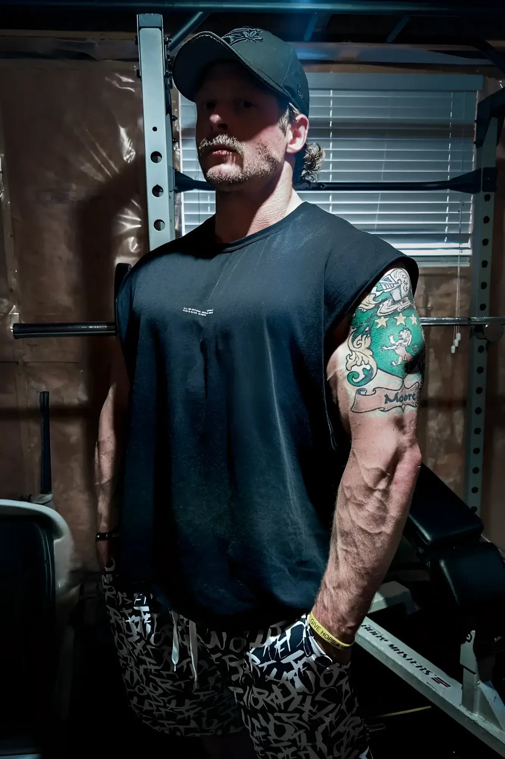 Black sleeveless athletic shirt with small white Jed North logo on chest designed for workout and casual wear