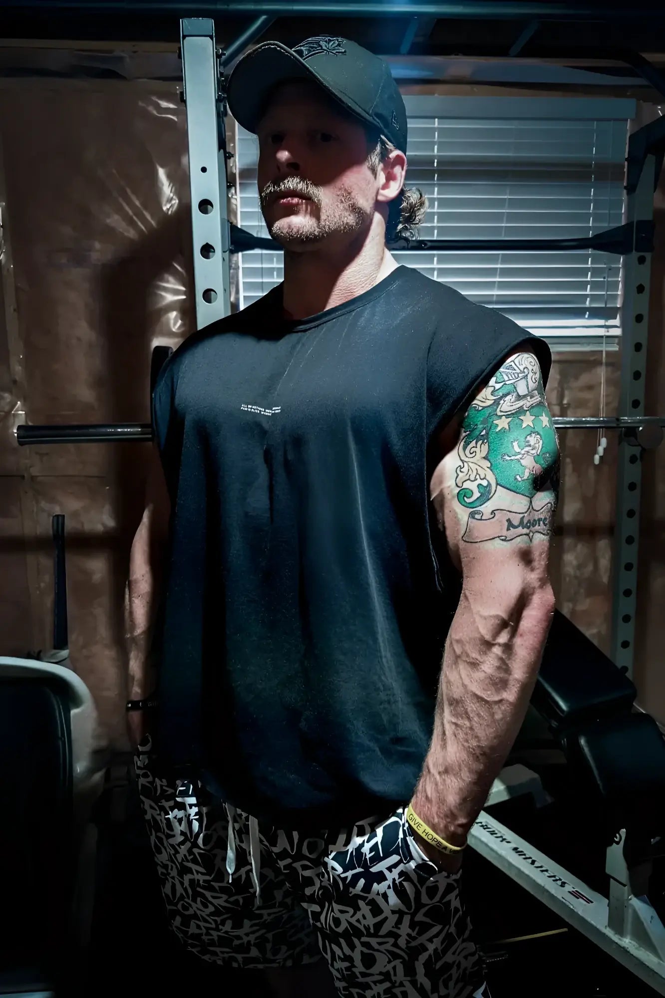 Black sleeveless athletic shirt with small white Jed North logo on chest designed for workout and casual wear