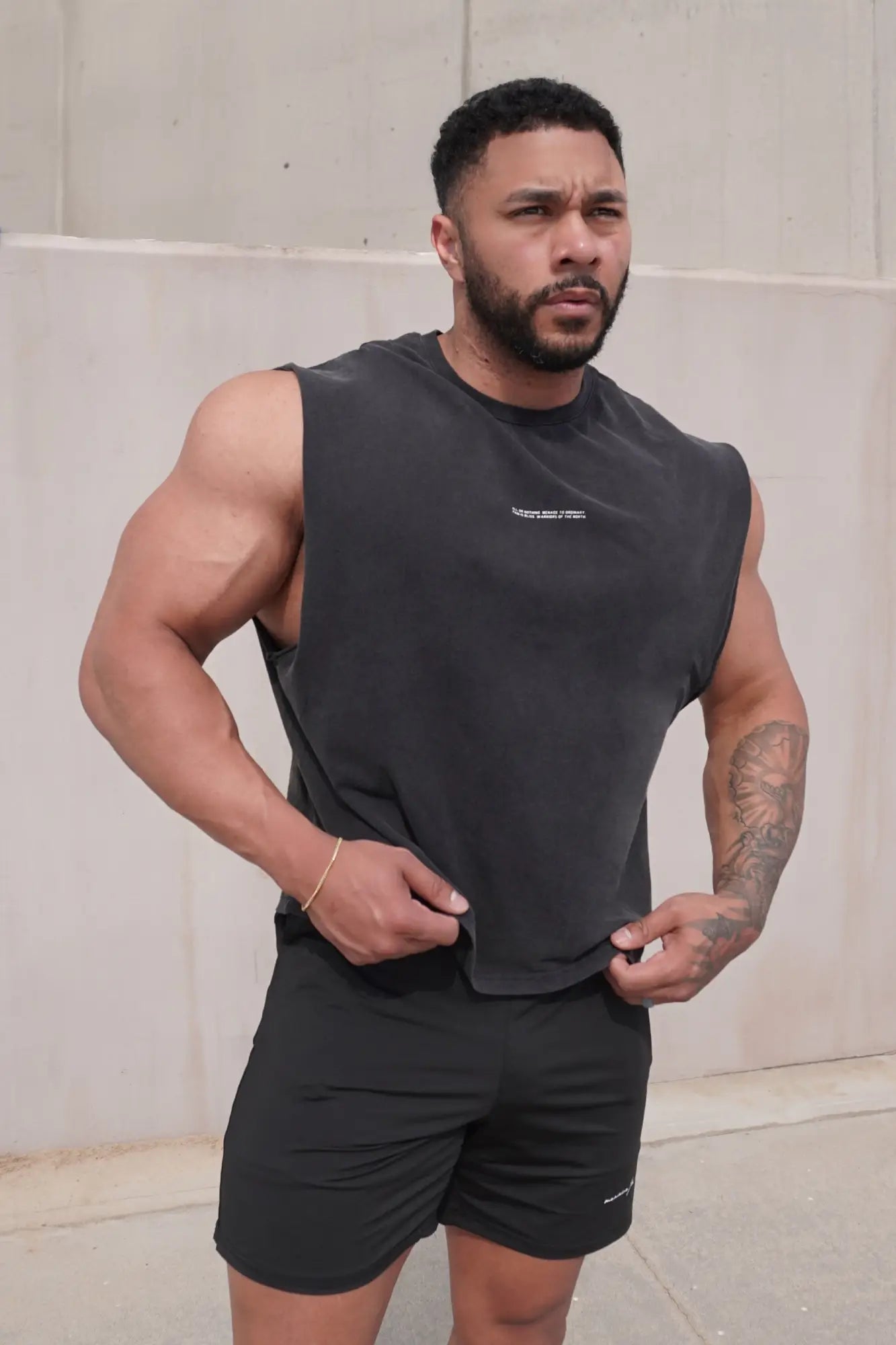 Jed North sleeveless box cut tank top in black with a subtle white logo on the chest made from breathable athletic fabric