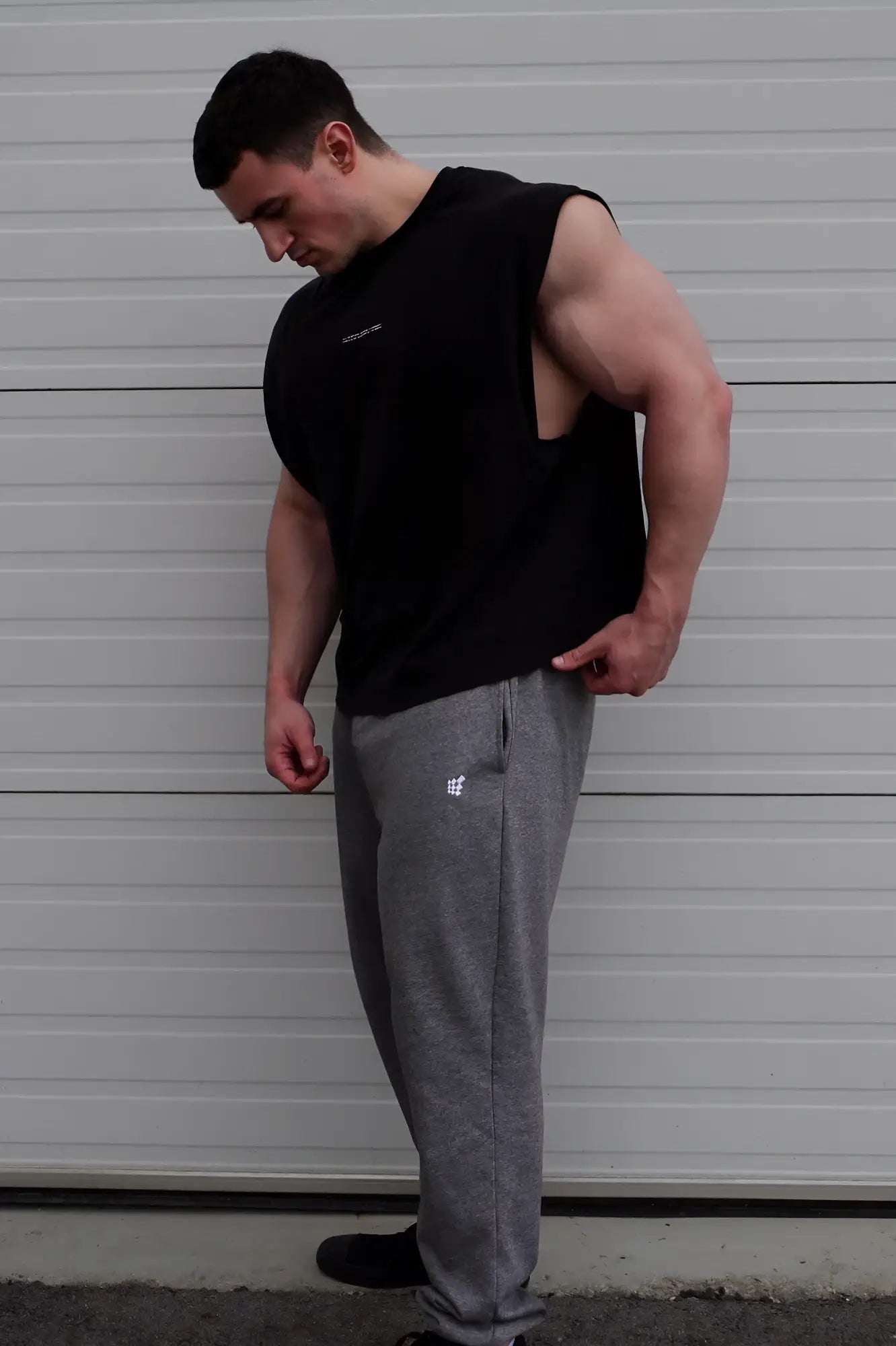 Black sleeveless muscle tee with cutout back detail by jed north ideal for gym and casual wear