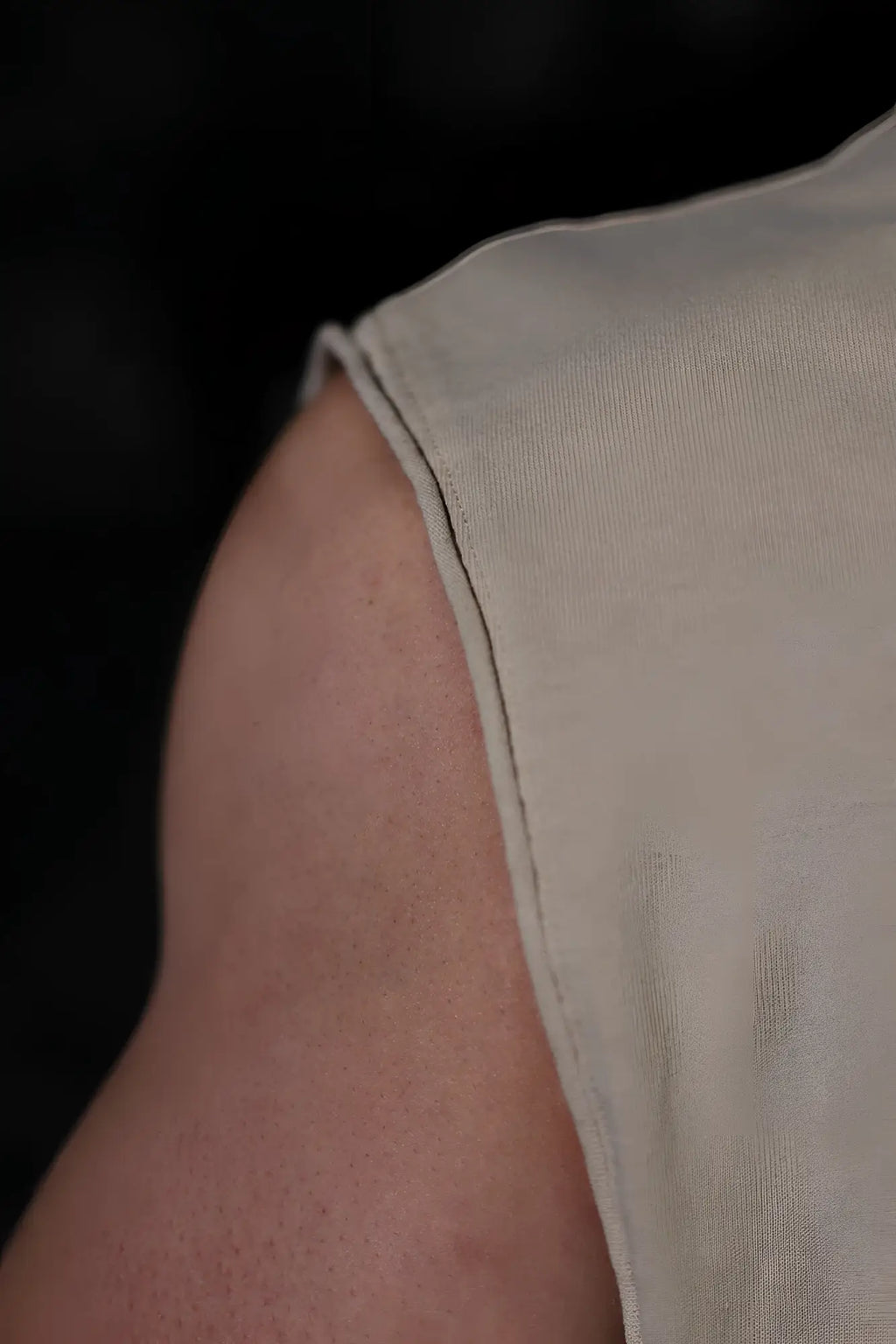 Beige sleeveless box cut tank top by jed north with clean straight seam along the shoulder in light khaki color