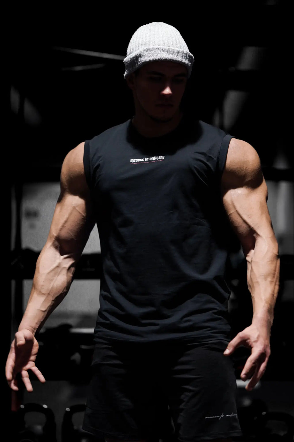 Black sleeveless athletic tank top with white text on chest by Jed North designed for muscle training and workouts