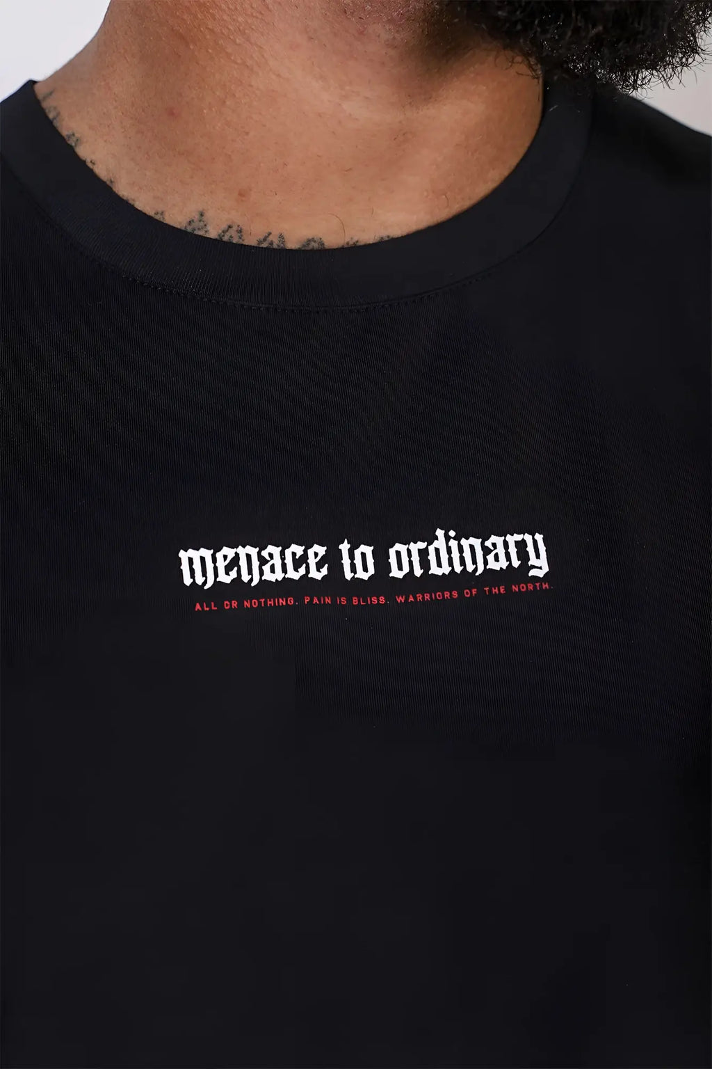 Black cotton Jed North sleeveless muscle tee with white and red gothic text menace to ordinary on chest