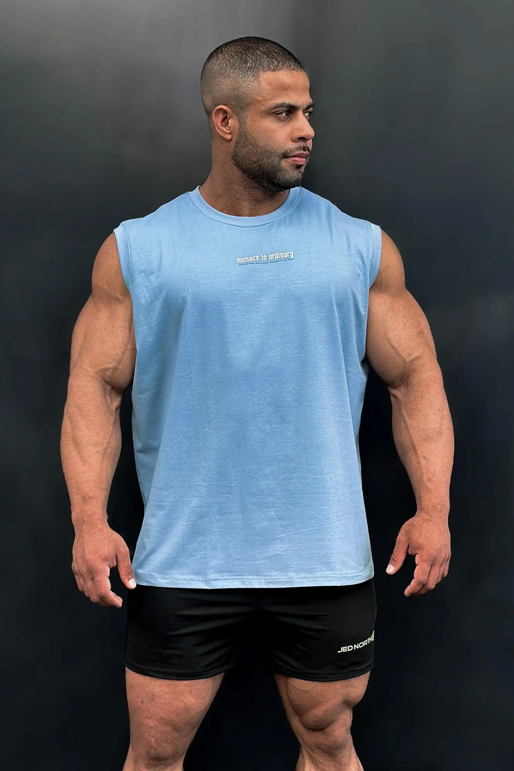 Jed North sleeveless muscle tee in light blue featuring a subtle white text logo across the chest