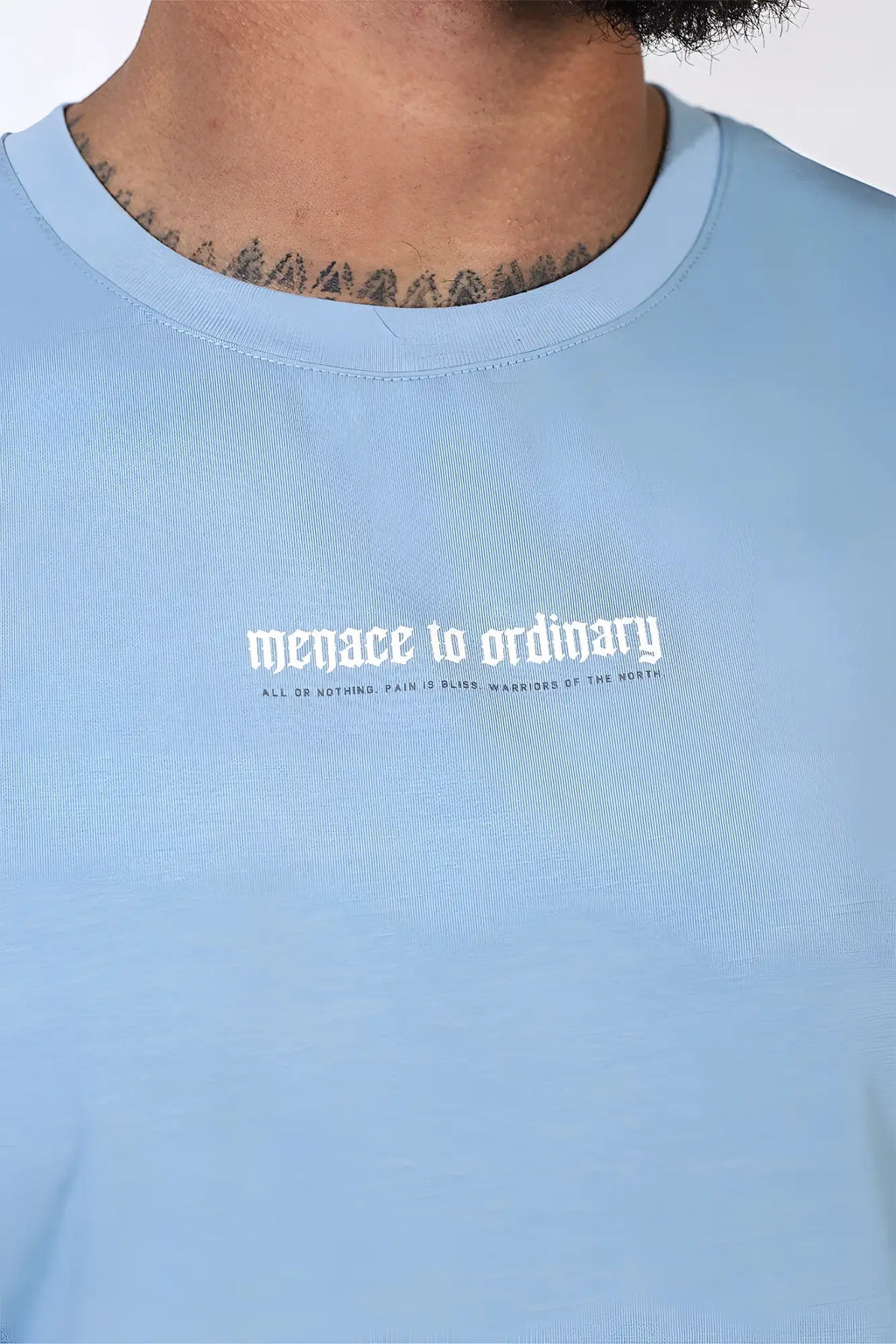 Jed North sleeveless muscle tee light blue with white gothic style menace to ordinary text on front
