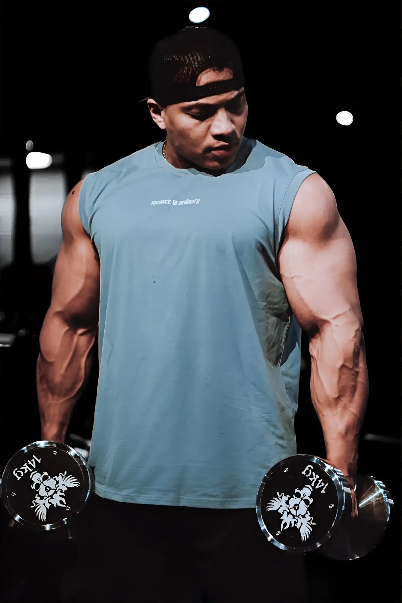 A man wearing a light blue sleeveless Jed North muscle tee with white text on the chest for athletic use
