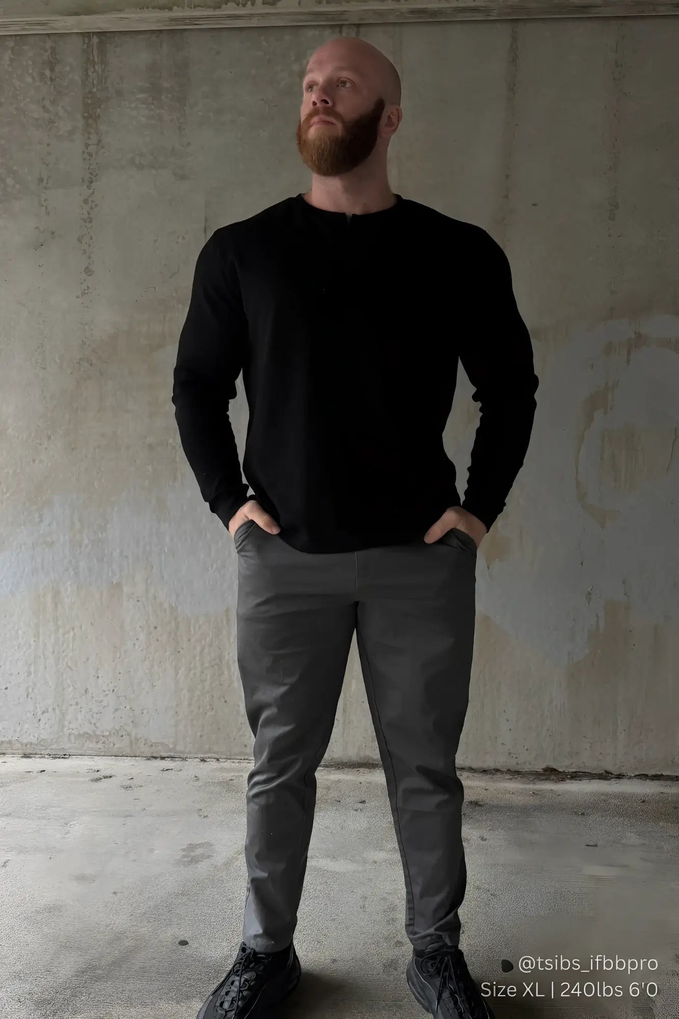 Black long-sleeved crewneck sweater paired with dark gray smart casual chino pants for versatile everyday wear
