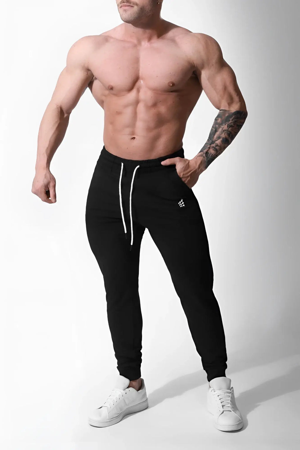 Black spirit joggers with white drawstrings and logo on left thigh designed for athletic wear and comfort