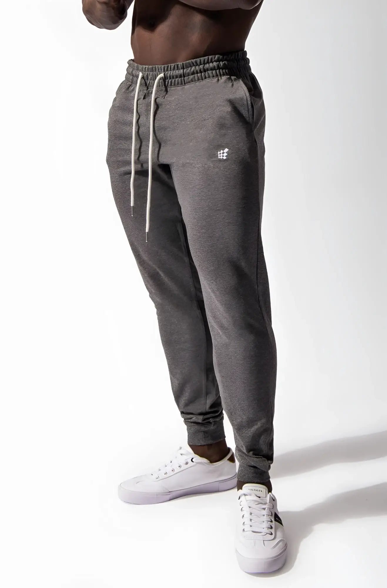 Dark gray heathered spirit joggers with white drawstrings and embroidered logo on left thigh in comfortable fabric