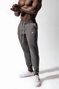 Dark gray heathered spirit joggers with white drawstrings and small embroidered logo on the thigh