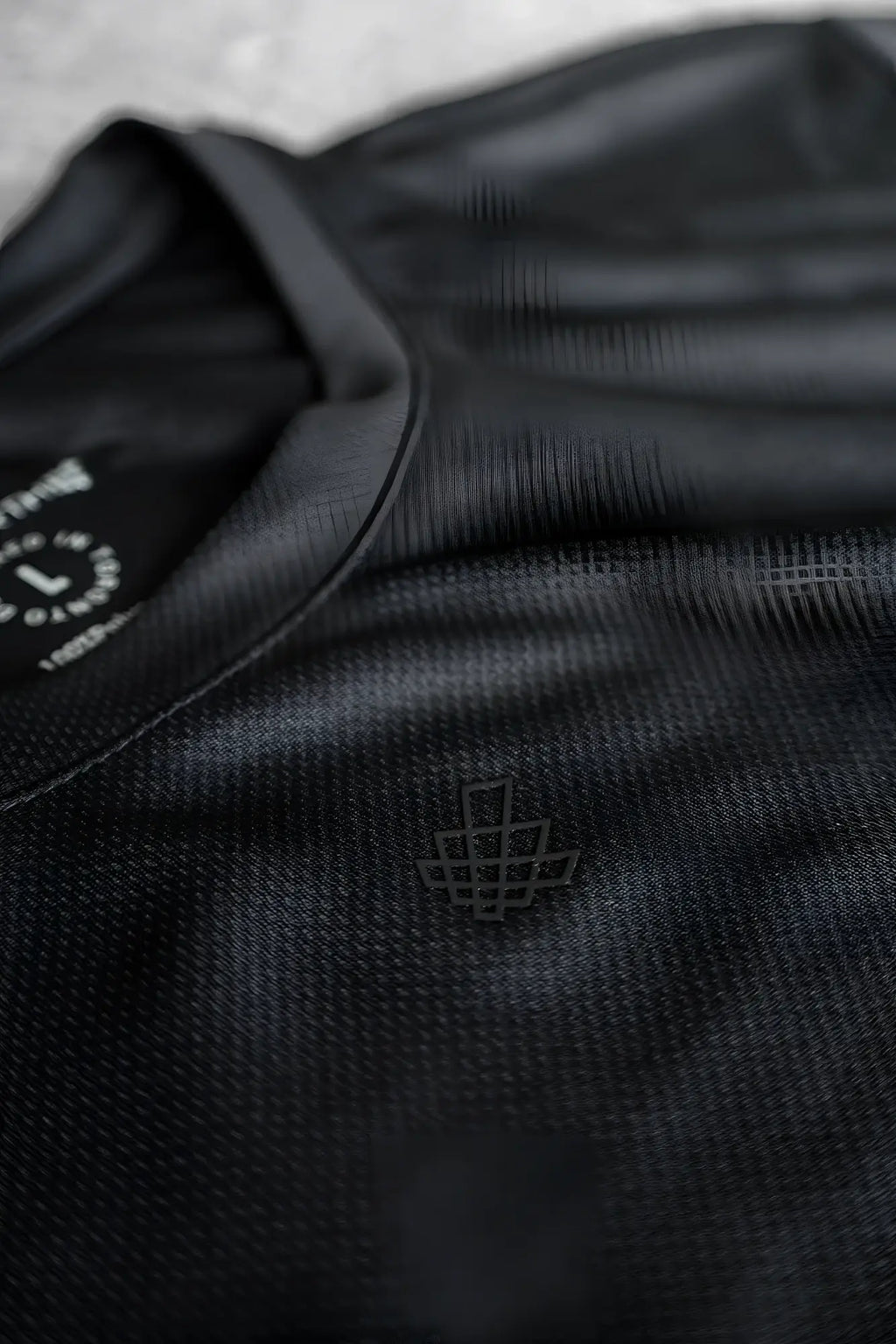 Jed North tactical fast-dry training t-shirt in obsidian black with textured weave and minimalist geometric logo on chest