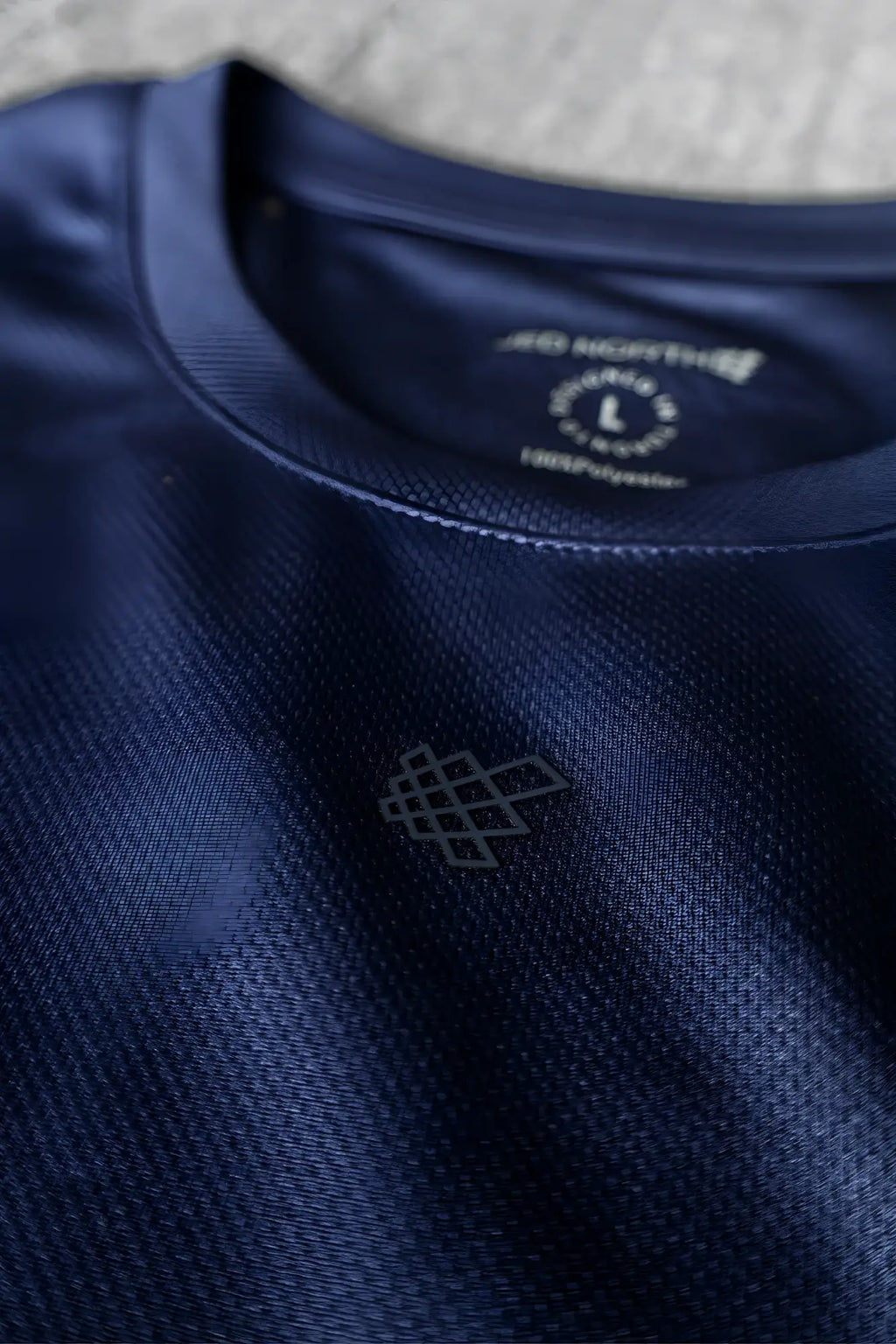 Jed North tactical fast-dry training t-shirt in dark navy blue with subtle textured weave and geometric chest logo