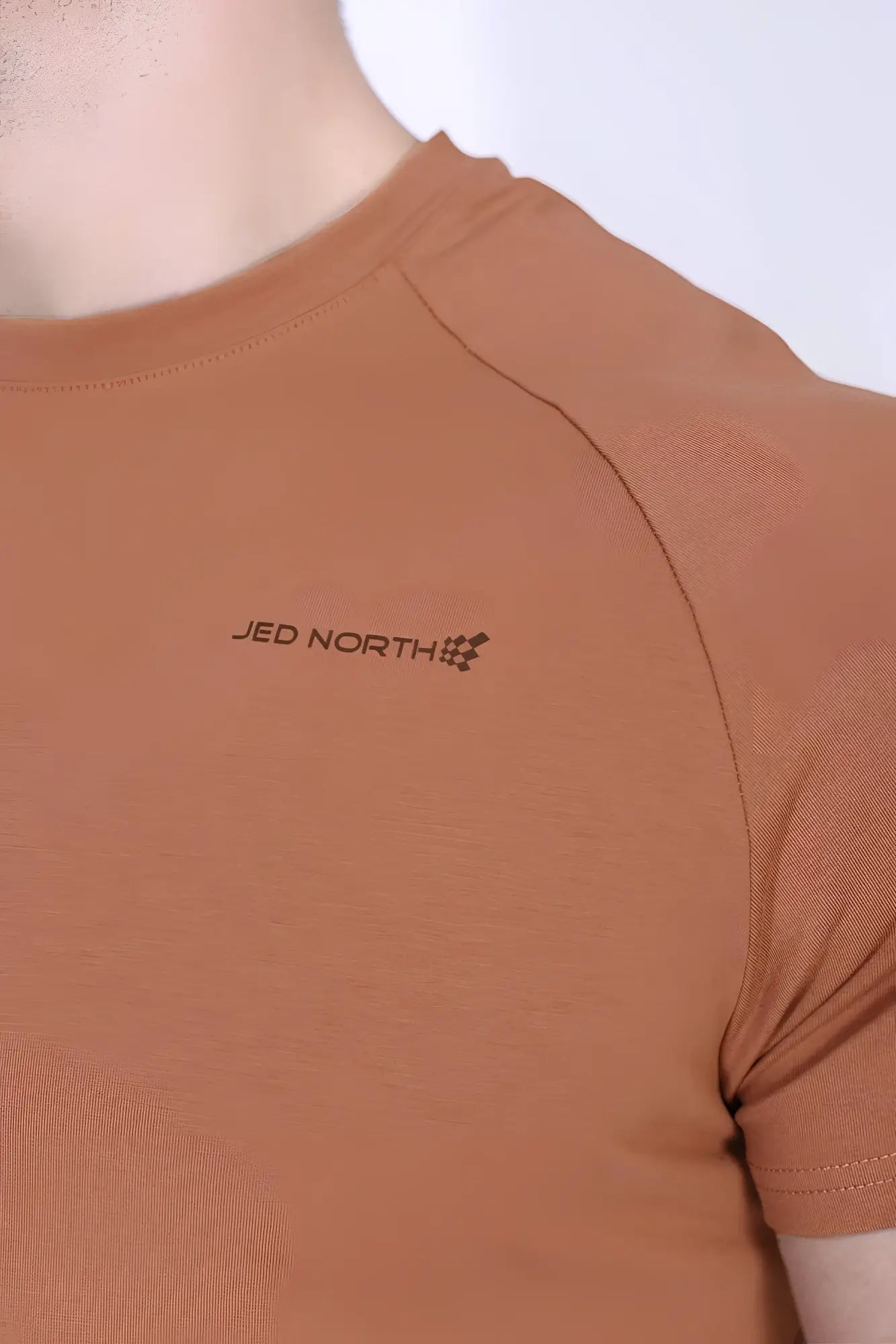 Jed north titan 2.0 muscle fit t shirt in copper with rust colored textured fabric and embroidered logo on the chest