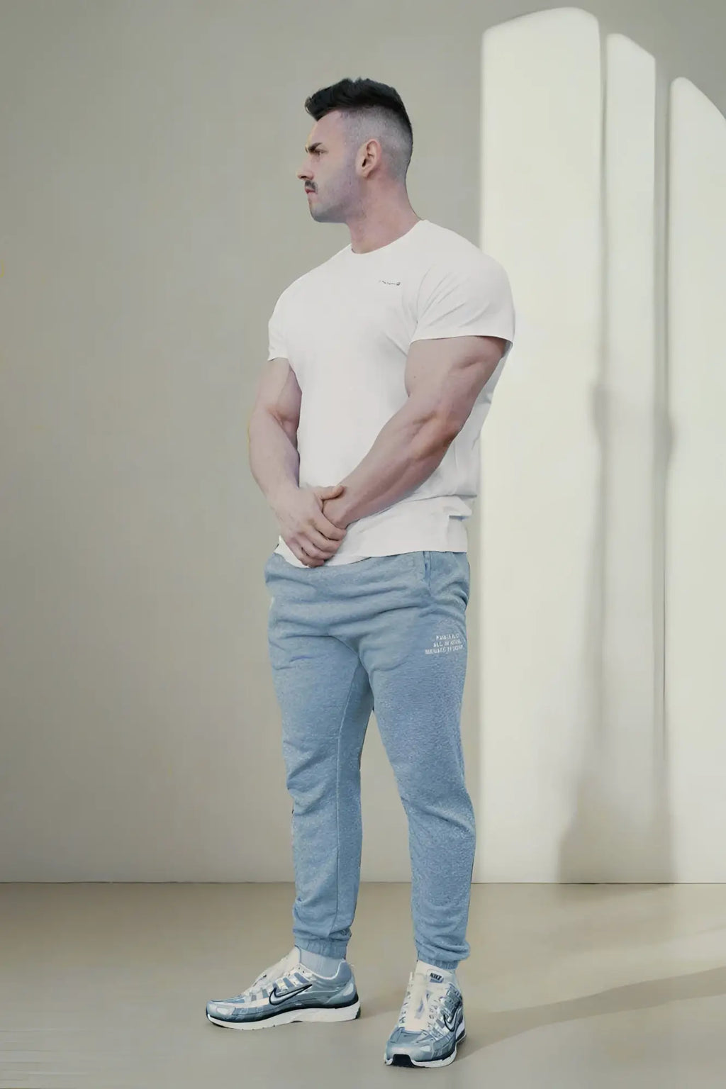 Light blue heathered jogger pants with a subtle logo on the left thigh paired with jed north titan 2.0 muscle-fit white t-shirt