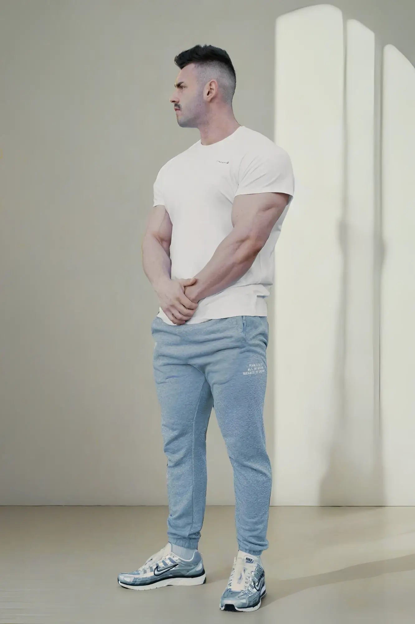 Light blue heathered jogger pants with a subtle logo on the left thigh paired with jed north titan 2.0 muscle-fit white t-shirt