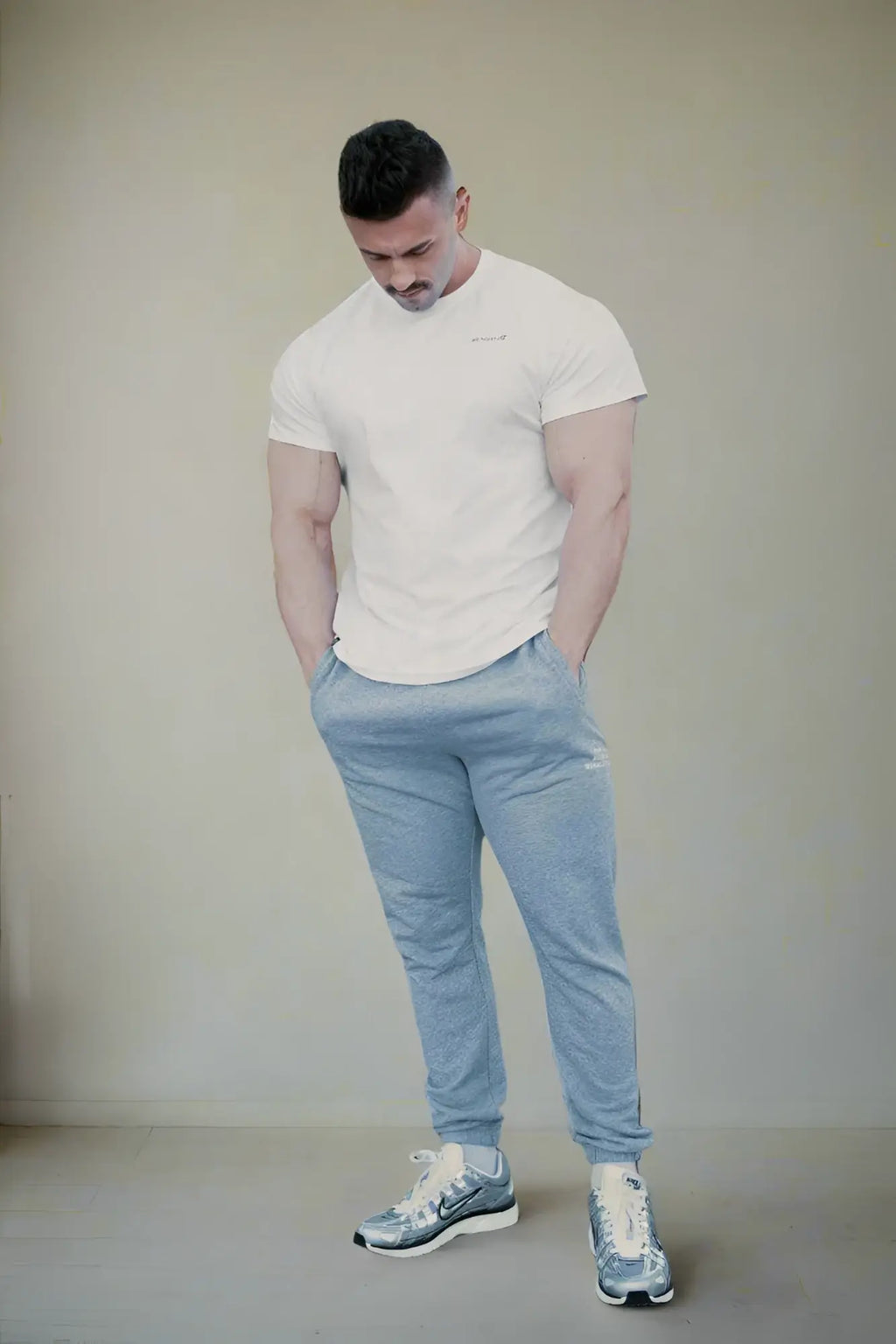 Light blue jogger pants with subtle textured fabric and elastic cuffs paired with jed north titan 2.0 muscle-fit t-shirt white