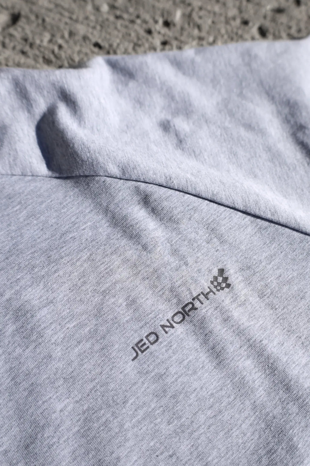 Gray heathered Jed North Titan muscle-fit long sleeve t-shirt with embroidered logo near the collar in platinum color