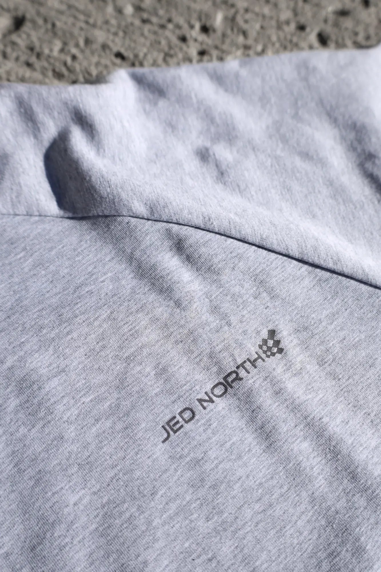 Gray heathered Jed North Titan muscle-fit long sleeve t-shirt with embroidered logo near the collar in platinum color