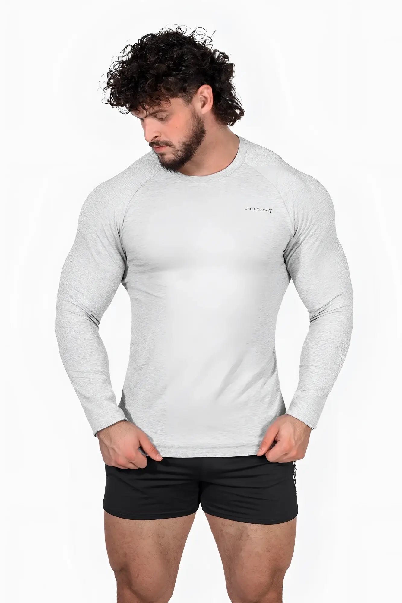 A men’s heather gray jed north titan muscle fit long sleeve athletic shirt with subtle texture and chest logo