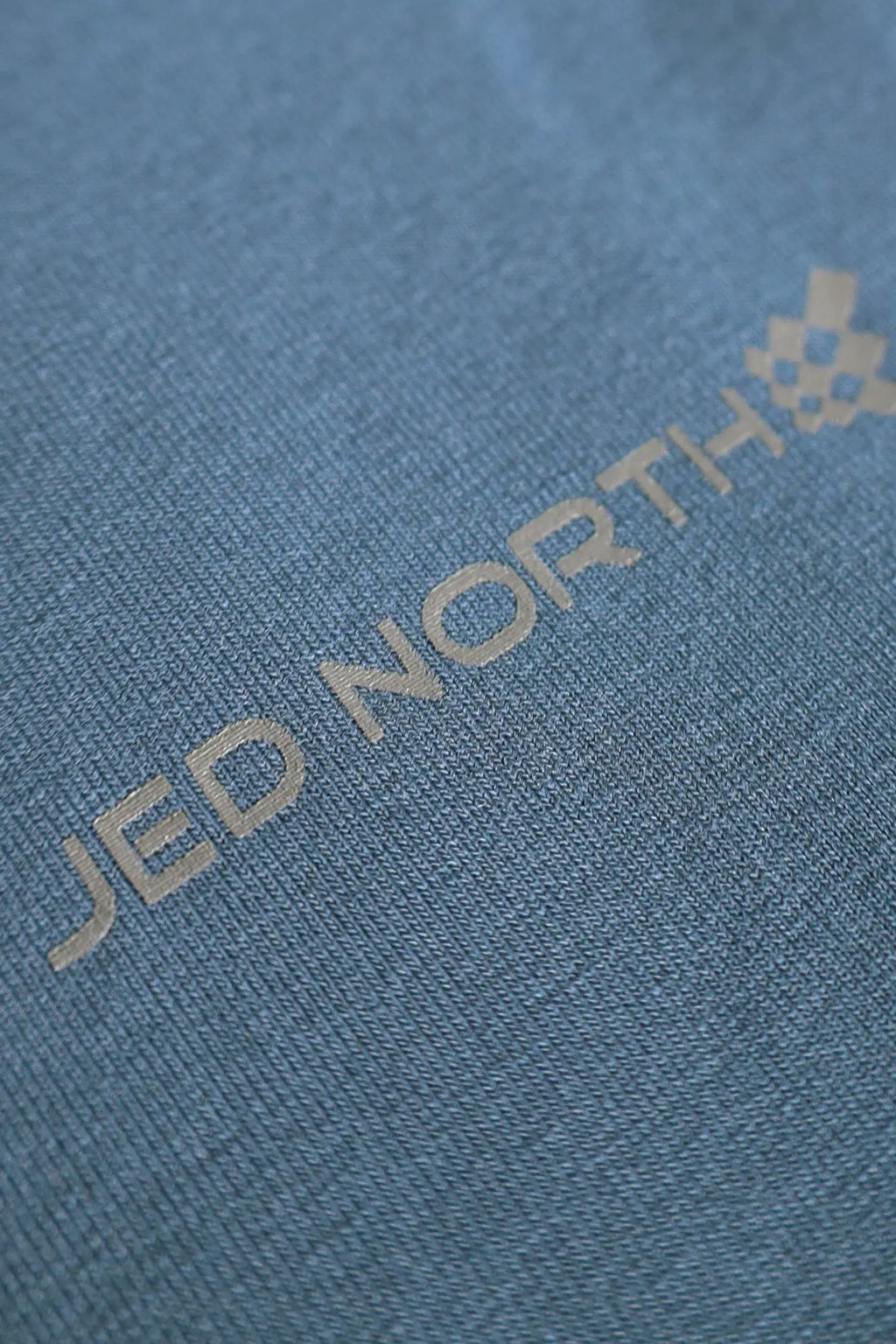 Jed North Titan muscle-fit long sleeve t-shirt in steel blue cotton with subtle gray jed north logo and checkered emblem