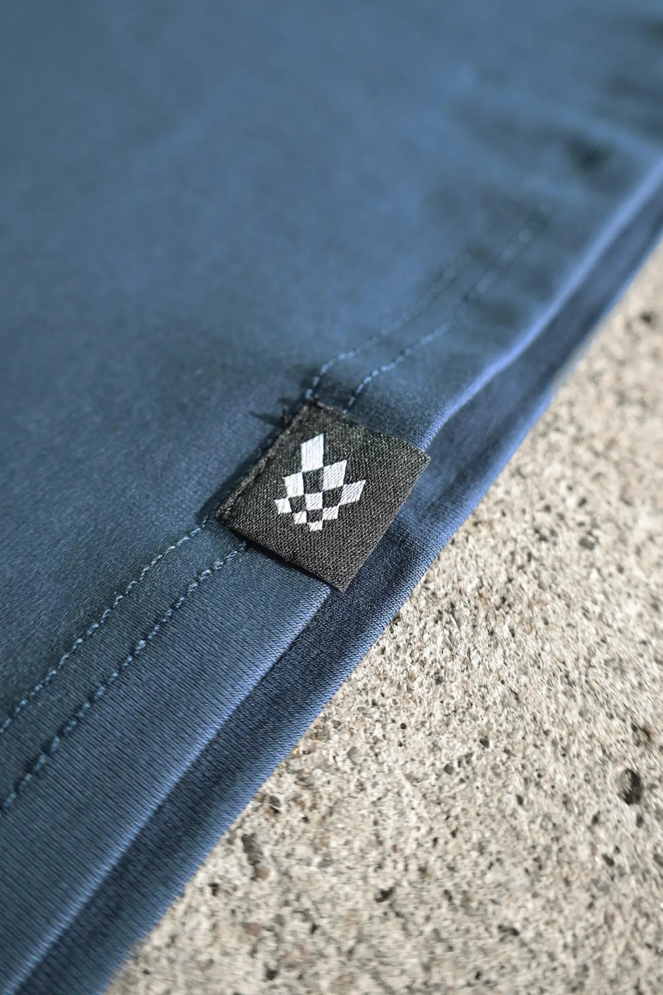 Jed north titan muscle fit long sleeve t shirt steel blue fabric with black woven label and white checkered logo