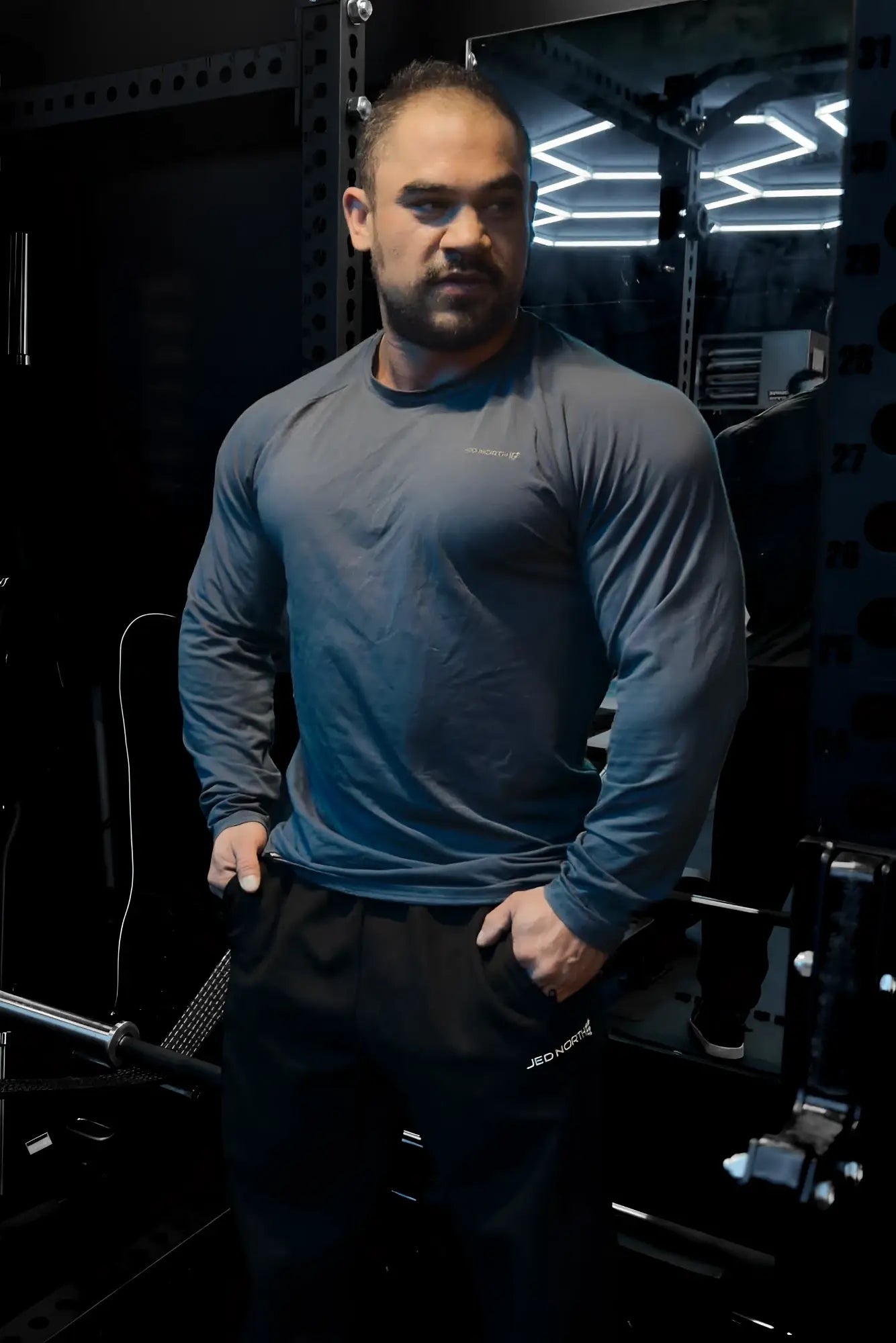 Jed North Titan muscle-fit long sleeve dark gray athletic shirt with subtle chest logo for performance wear