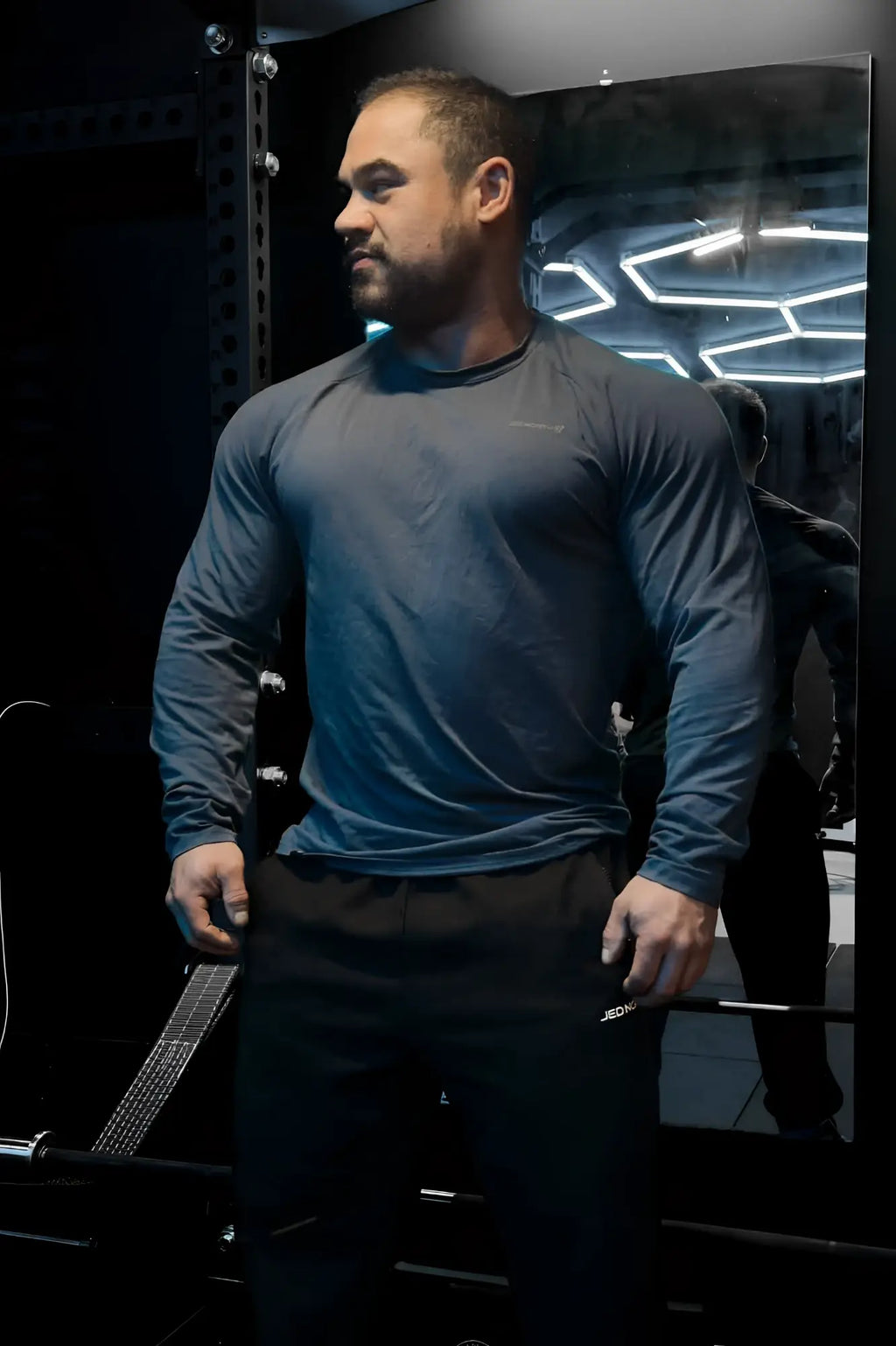 Dark gray jed north titan muscle-fit long sleeve athletic shirt with subtle chest logo in steel blue color