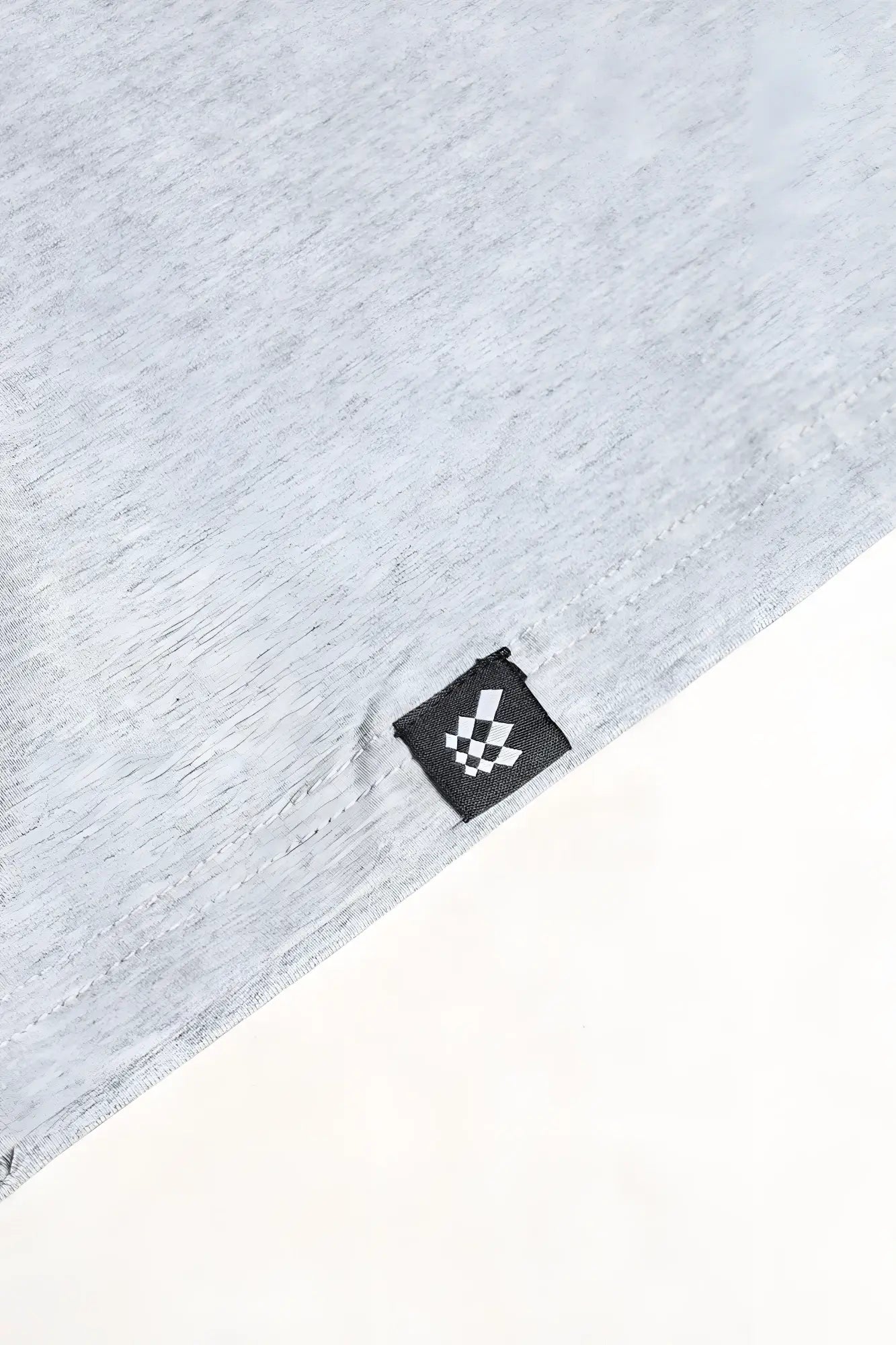 Light gray v neck muscle-fit t-shirt made of heathered cotton with a small black and white checkered tag at the hem
