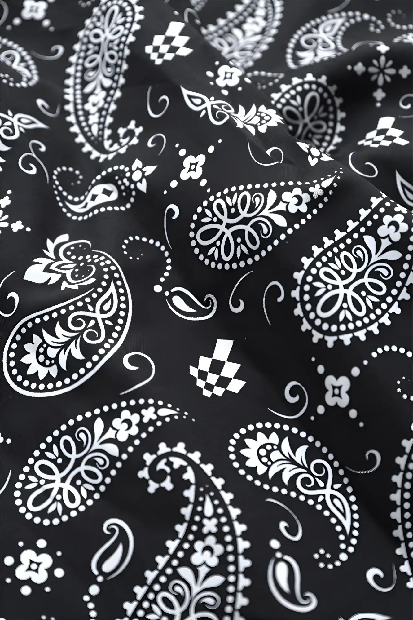 Black bandana with intricate white paisley and checkered patterns used in Jed North Vintage Flex Joggers Paisley design