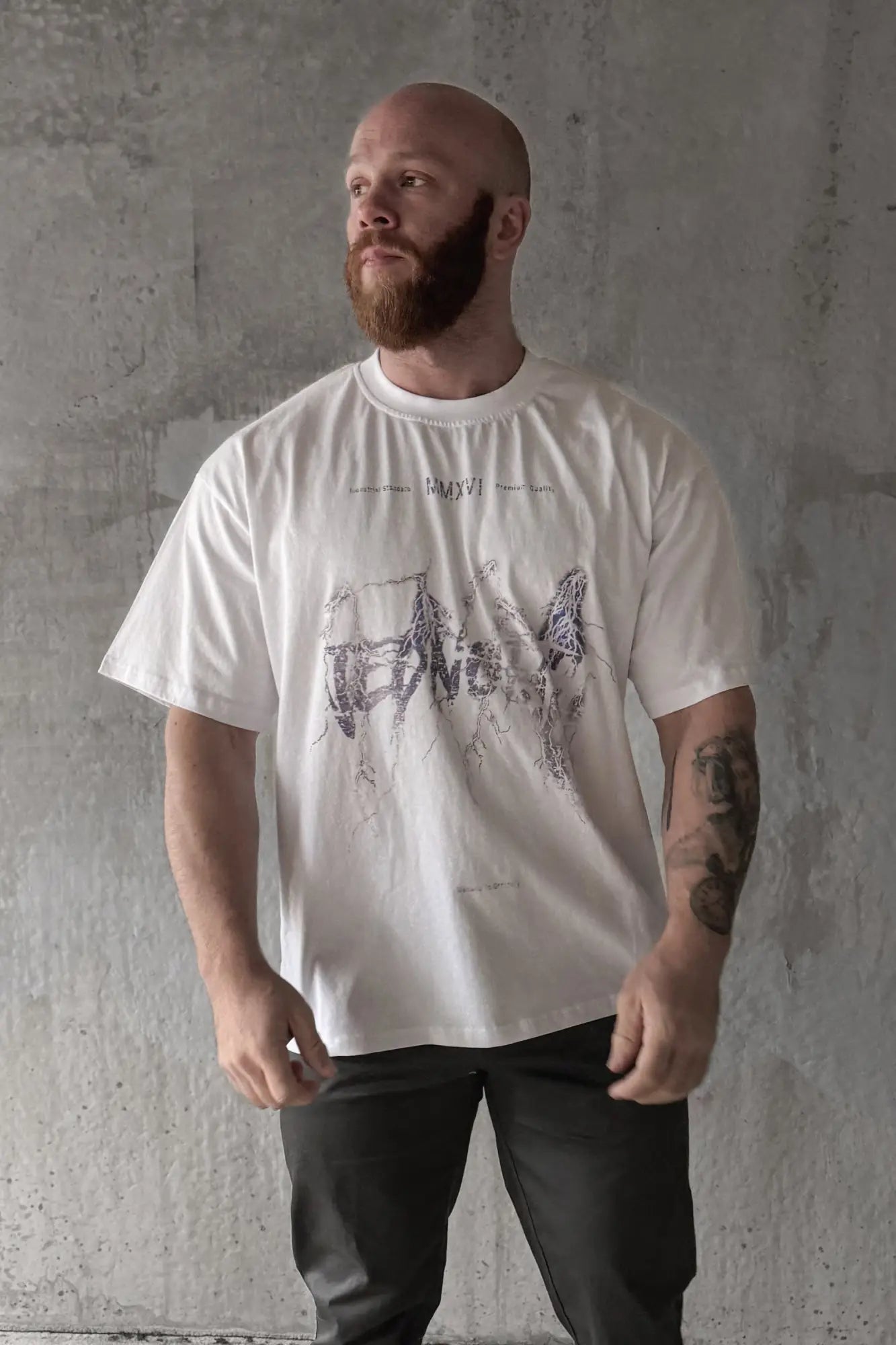 White oversized cotton t-shirt with a black intricate electric logo graphic print across the chest vintage style
