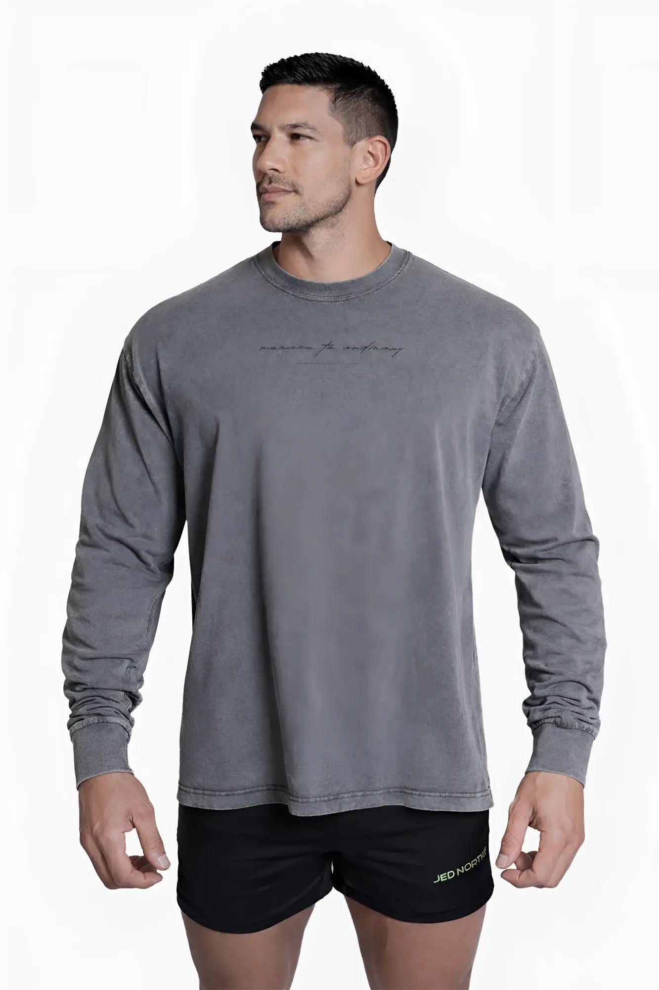 Vintage wash long sleeve t-shirt in storm gray with subtle faded texture and delicate black cursive lettering on chest