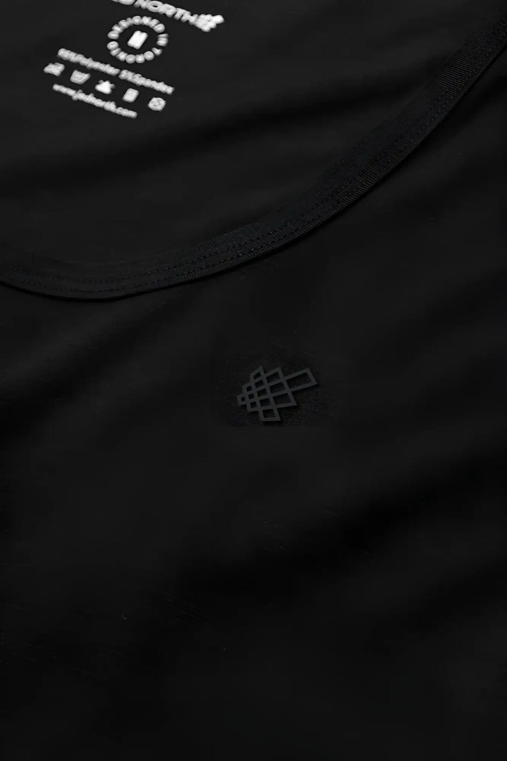 Black cotton Vital Raw-Hem Tank Top 2.0 with subtle geometric logo embroidery and brand tag at neckline