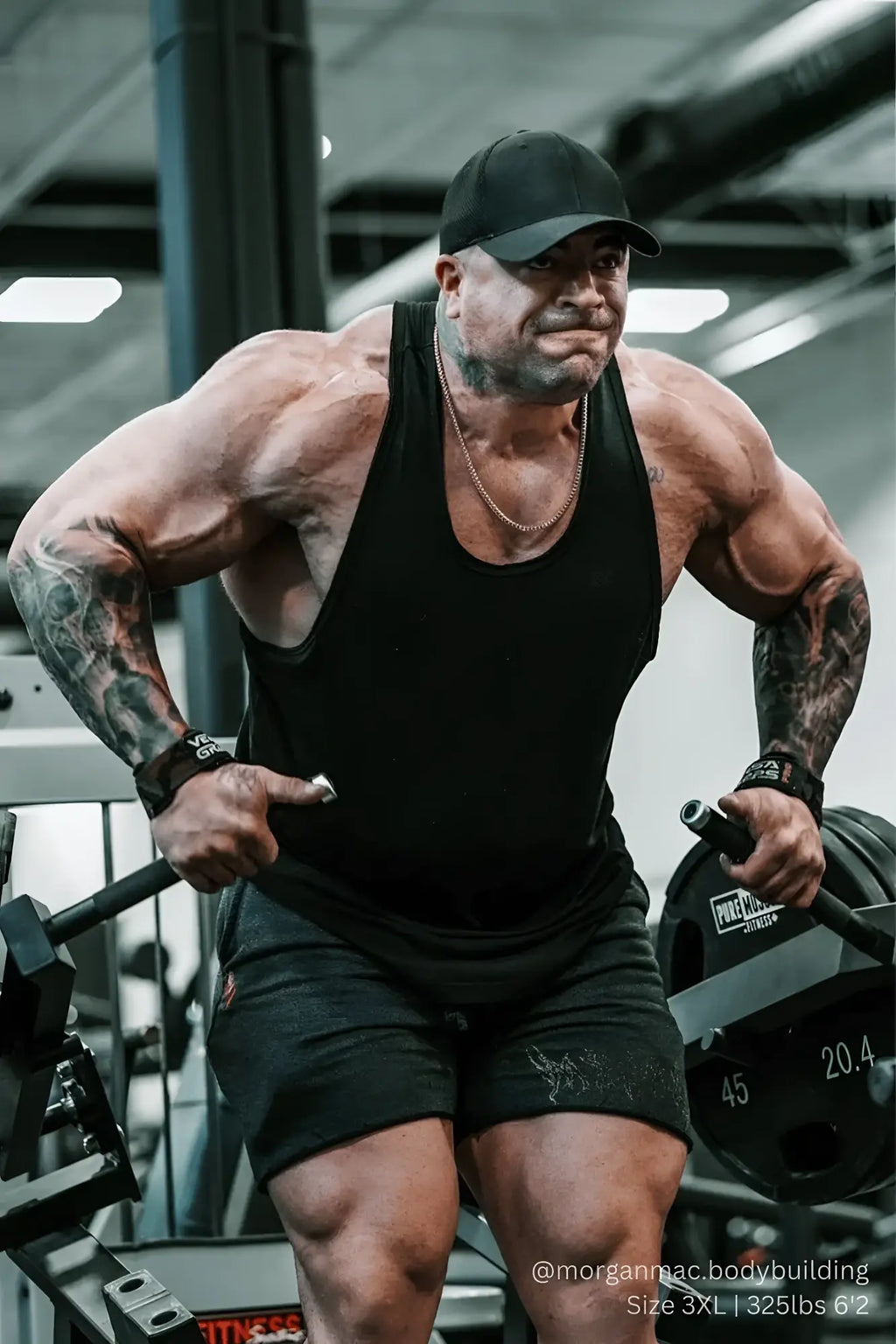 Man wearing a fitted black cotton Vital raw-hem tank top 2.0 designed for casual and active use