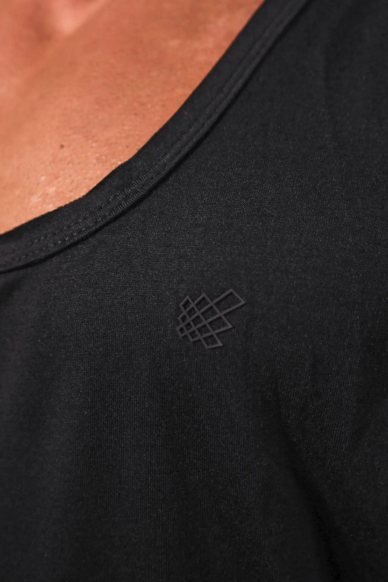 Black vital raw-hem tank top 2.0 with subtle geometric logo embroidered near the neckline