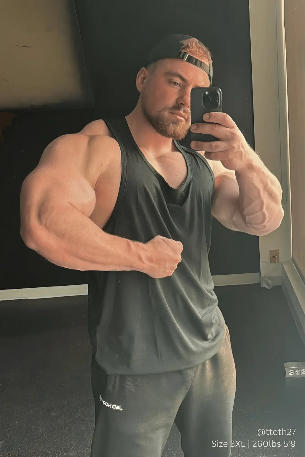 Black v-neck Vital Raw-Hem Tank Top 2.0 with slightly faded fabric worn by a muscular individual