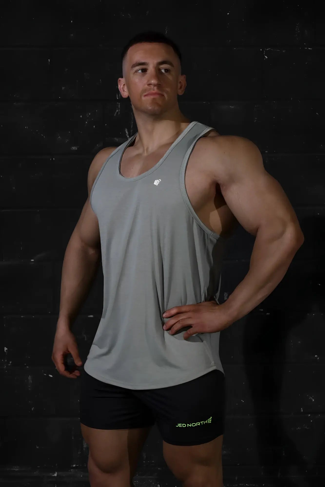 Gray sleeveless Jed North Vital Raw-Hem Tank Top 2.0 with small white chest logo for athletic wear
