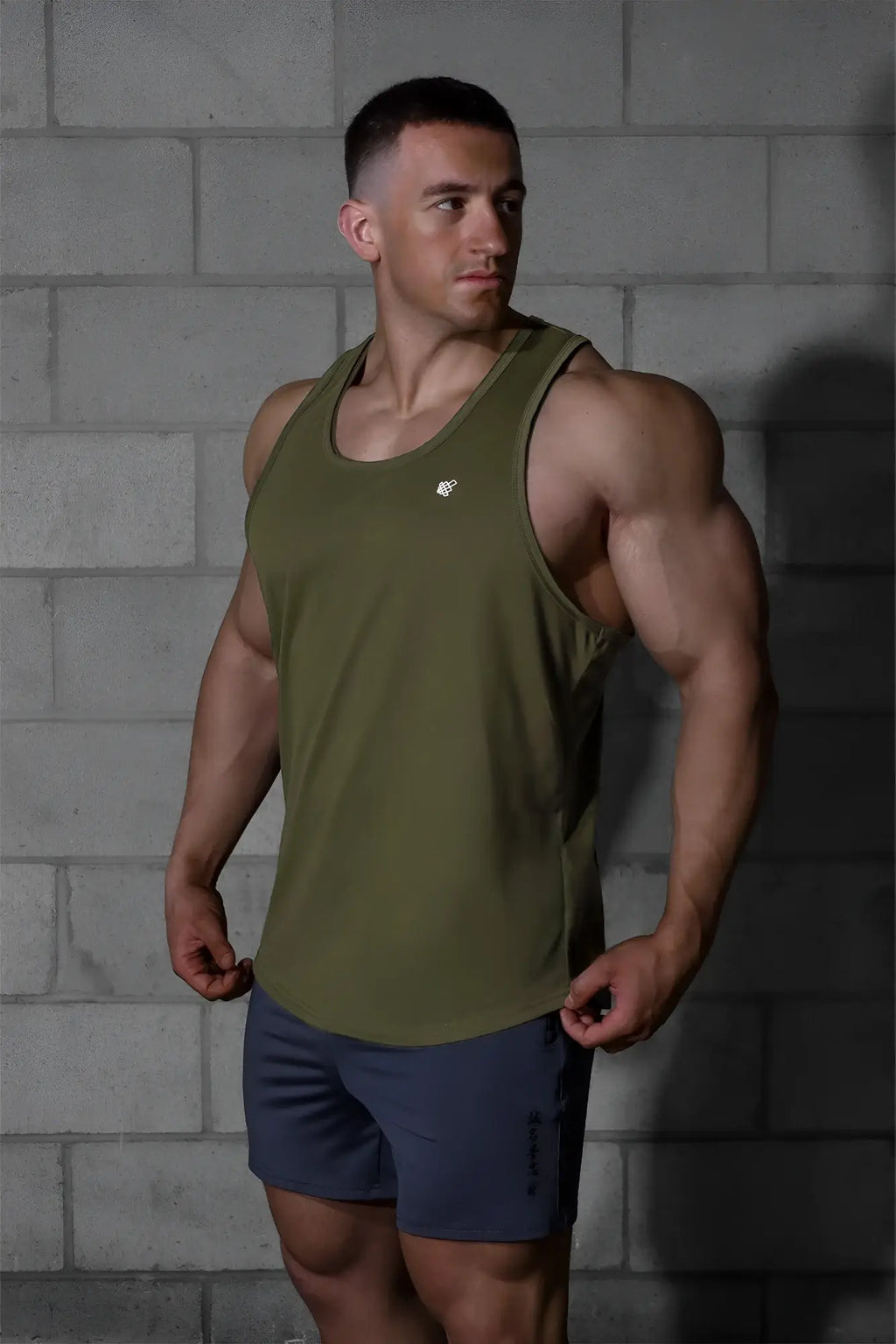 Jed North Vital raw-hem olive green athletic tank top with small chest logo designed for performance workouts