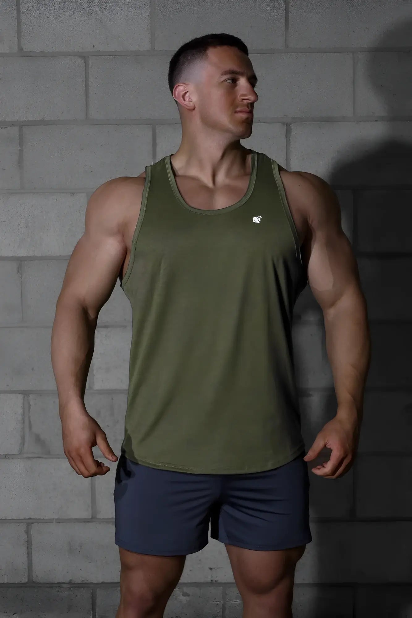 Olive green jed north vital raw-hem tank top 2.0 with small white logo on chest designed for athletic use