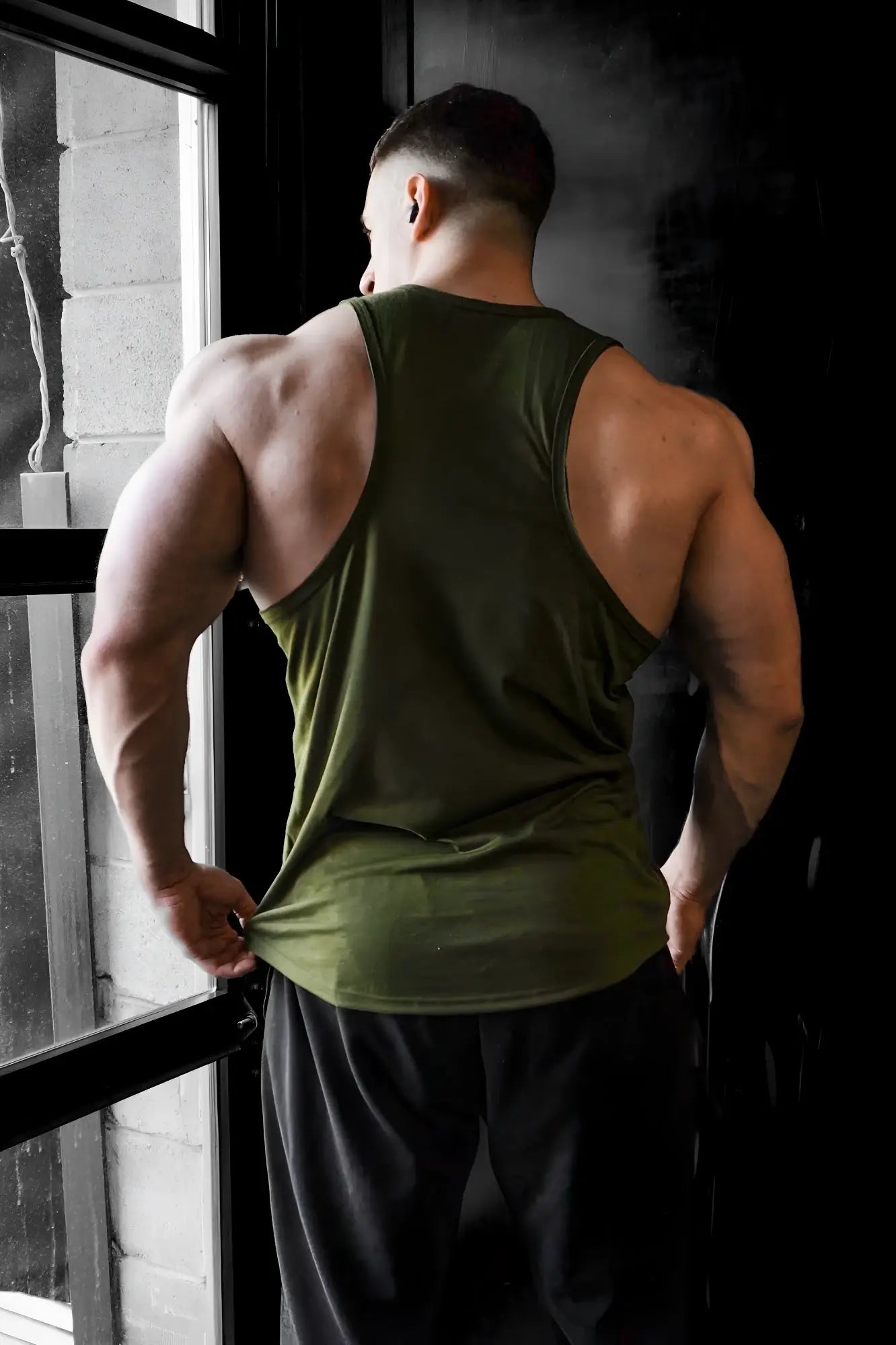 Olive green muscle tank top with raw hem by jed north made for workout and casual wear